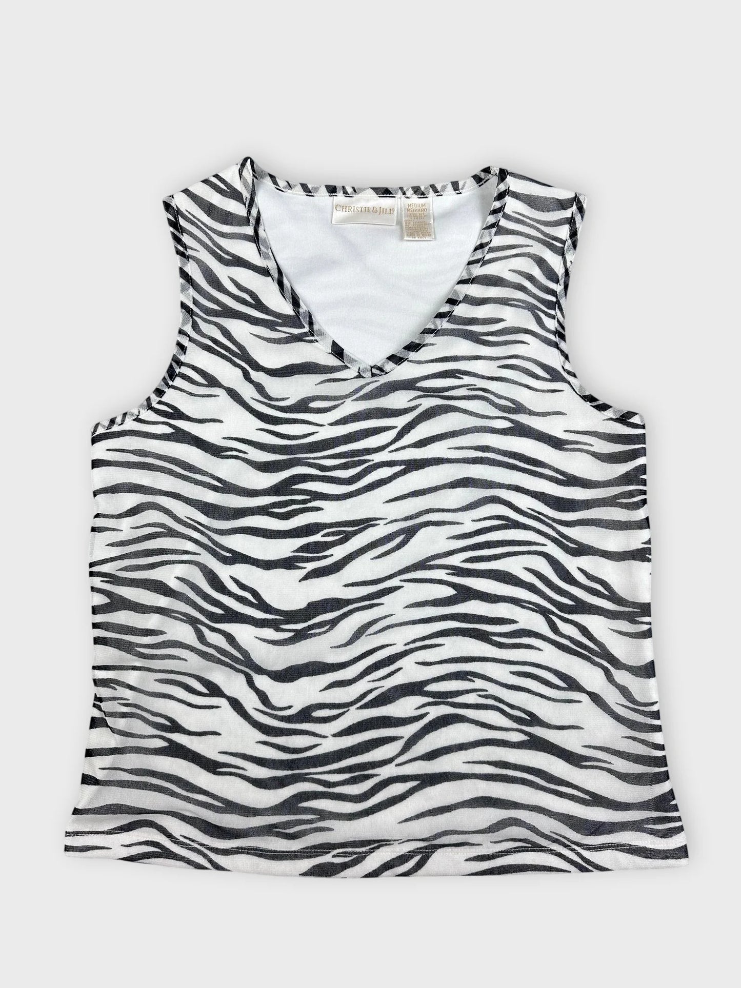 Detail view of a women’s sleeveless top in black and white zebra print.