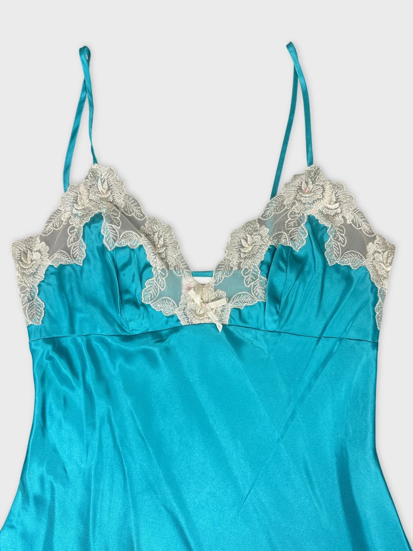 Detail view of turquoise upper body top with lace trim