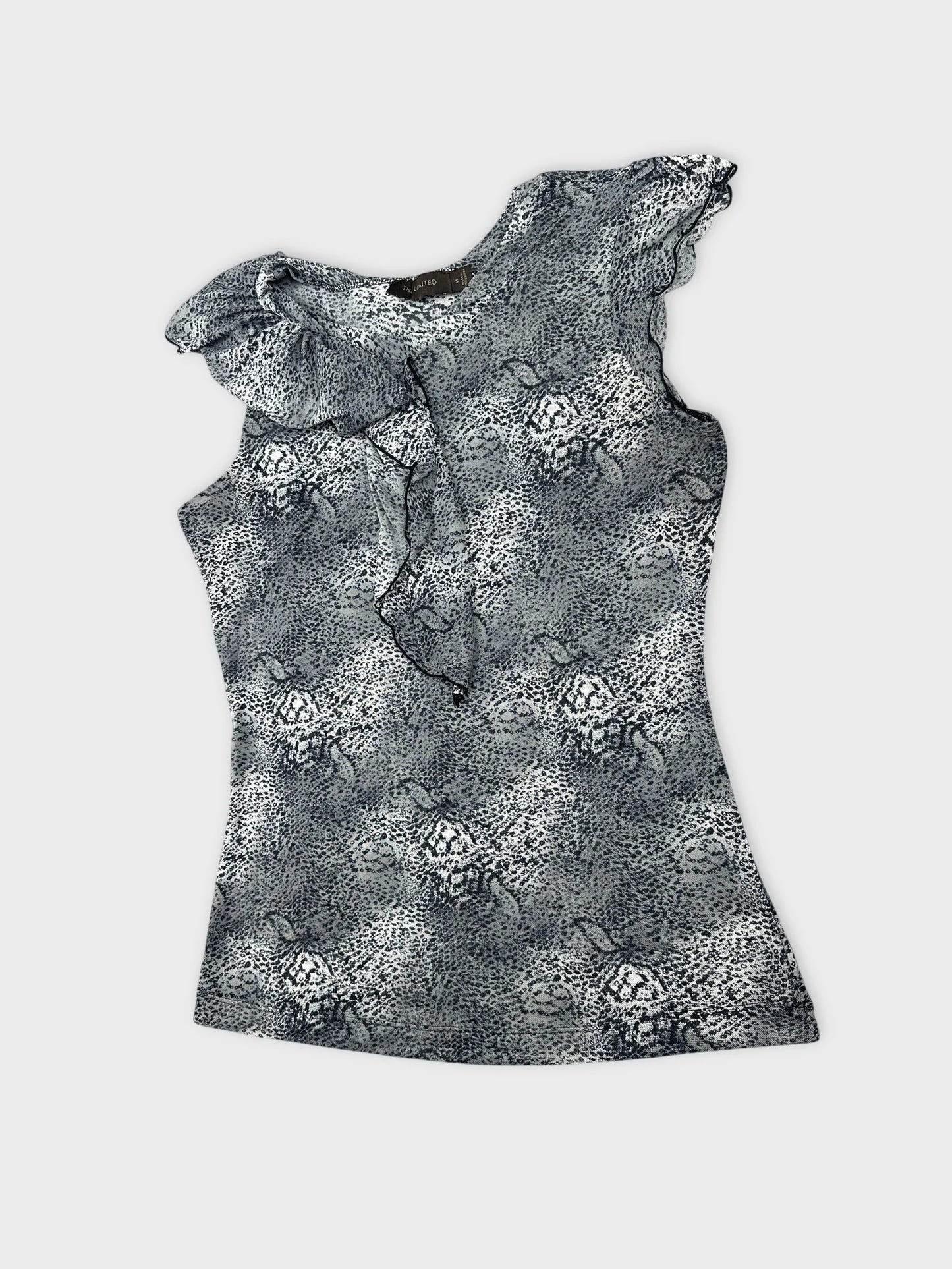 Detail view of a sleeveless top in black and white animal print.