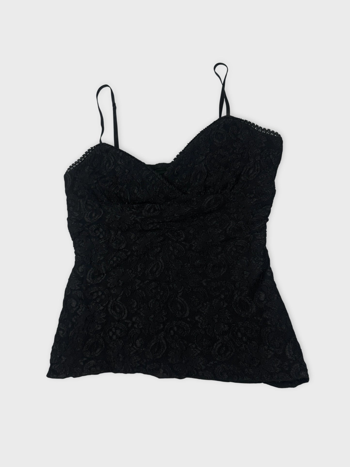 Detail view of a black lace camisole top with thin straps.