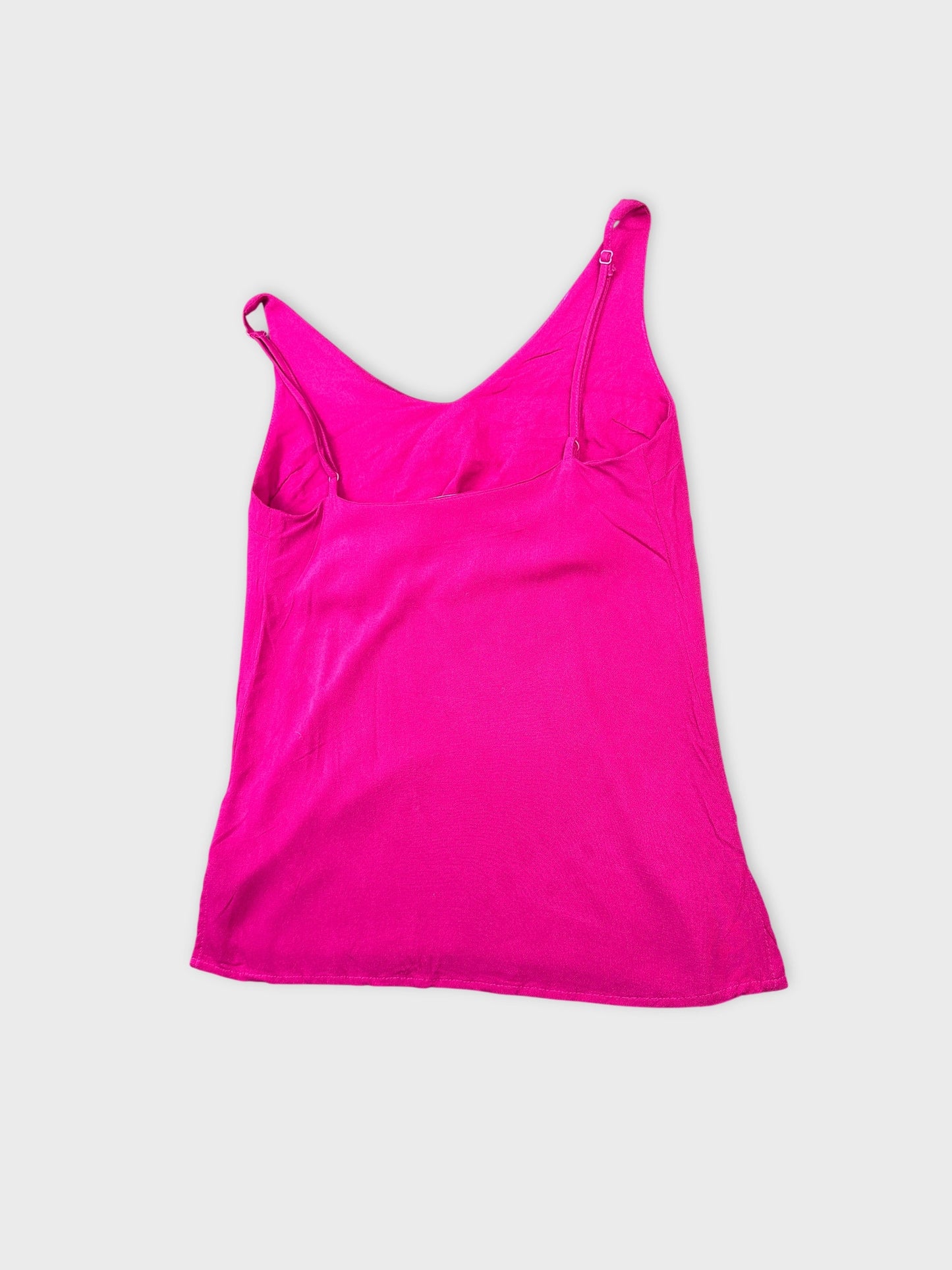 Detail view of a pink women's top with thin straps.