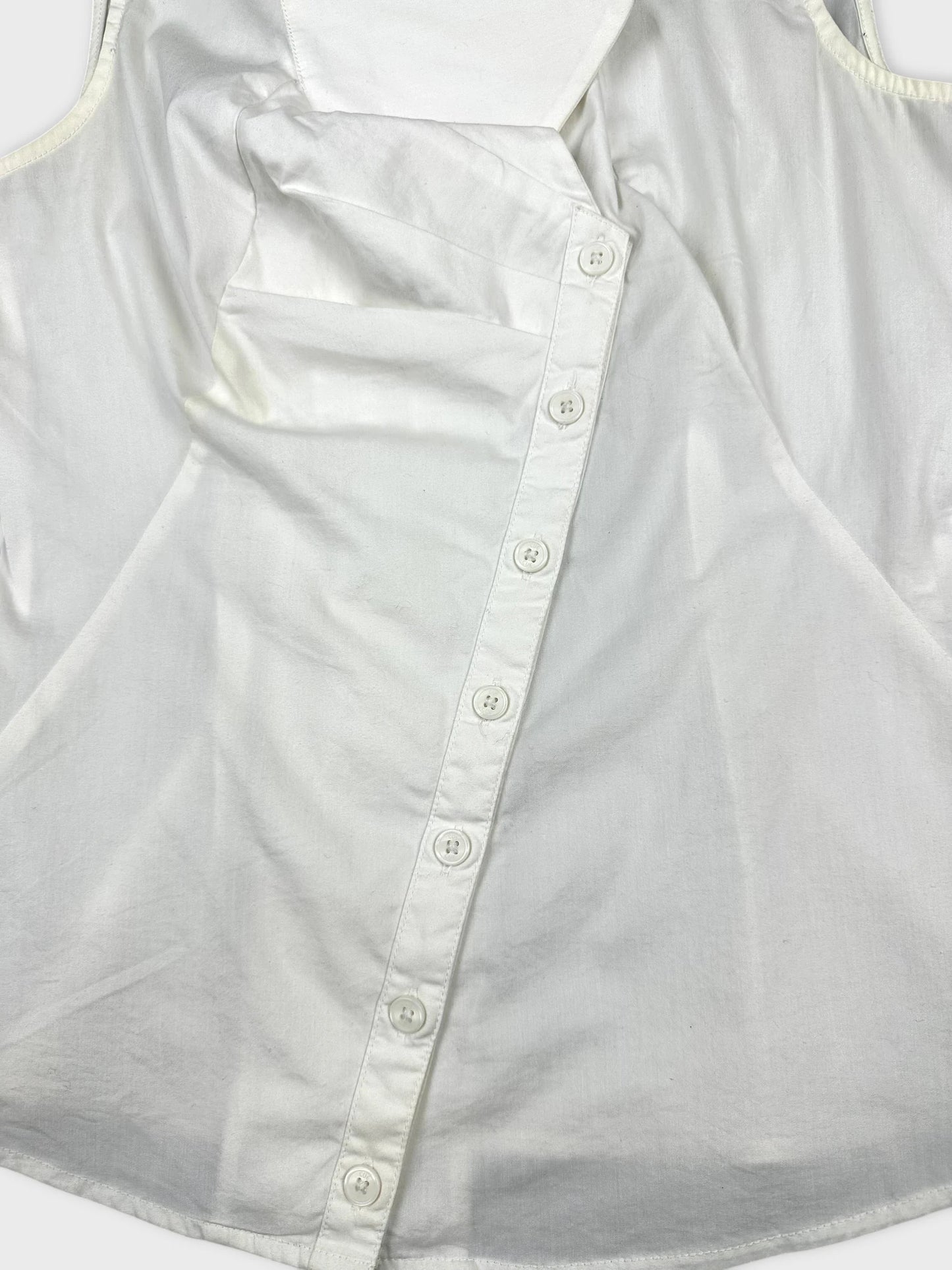 Detail view of a white women's top featuring button closures.