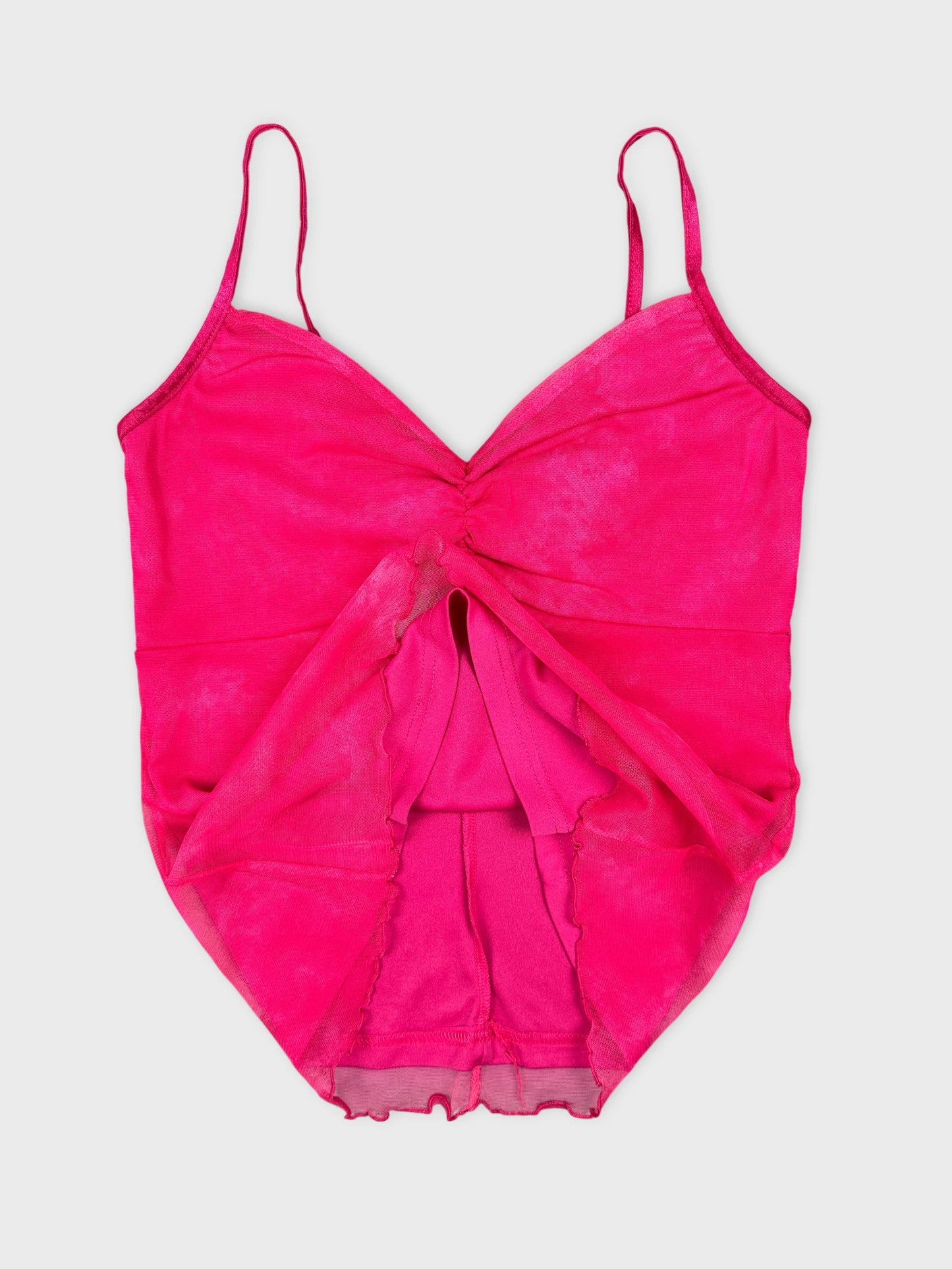 Pink top detail view featuring a twisted front design and spaghetti straps.