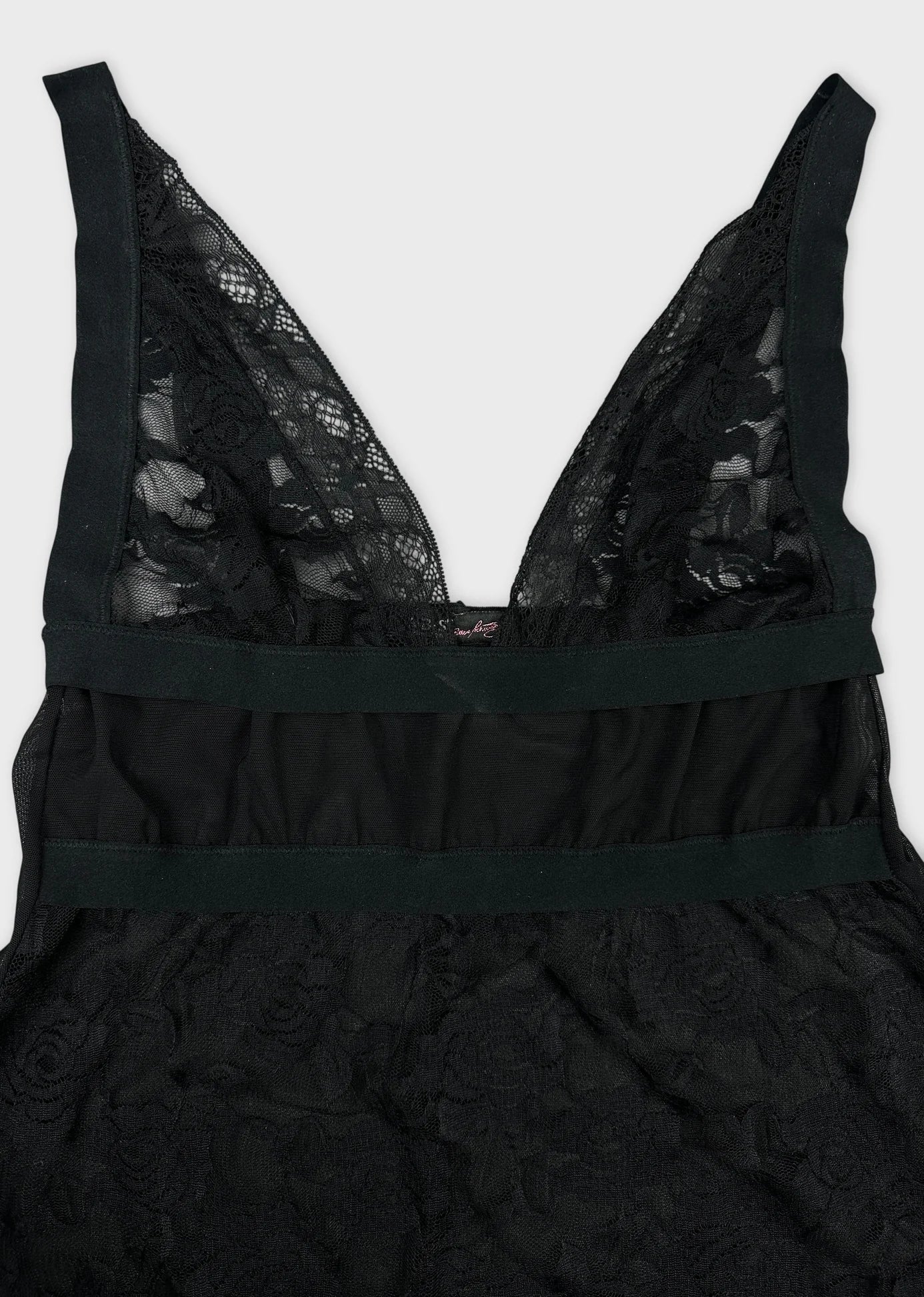 Detail view of a black lace women's top with a deep V-neckline.
