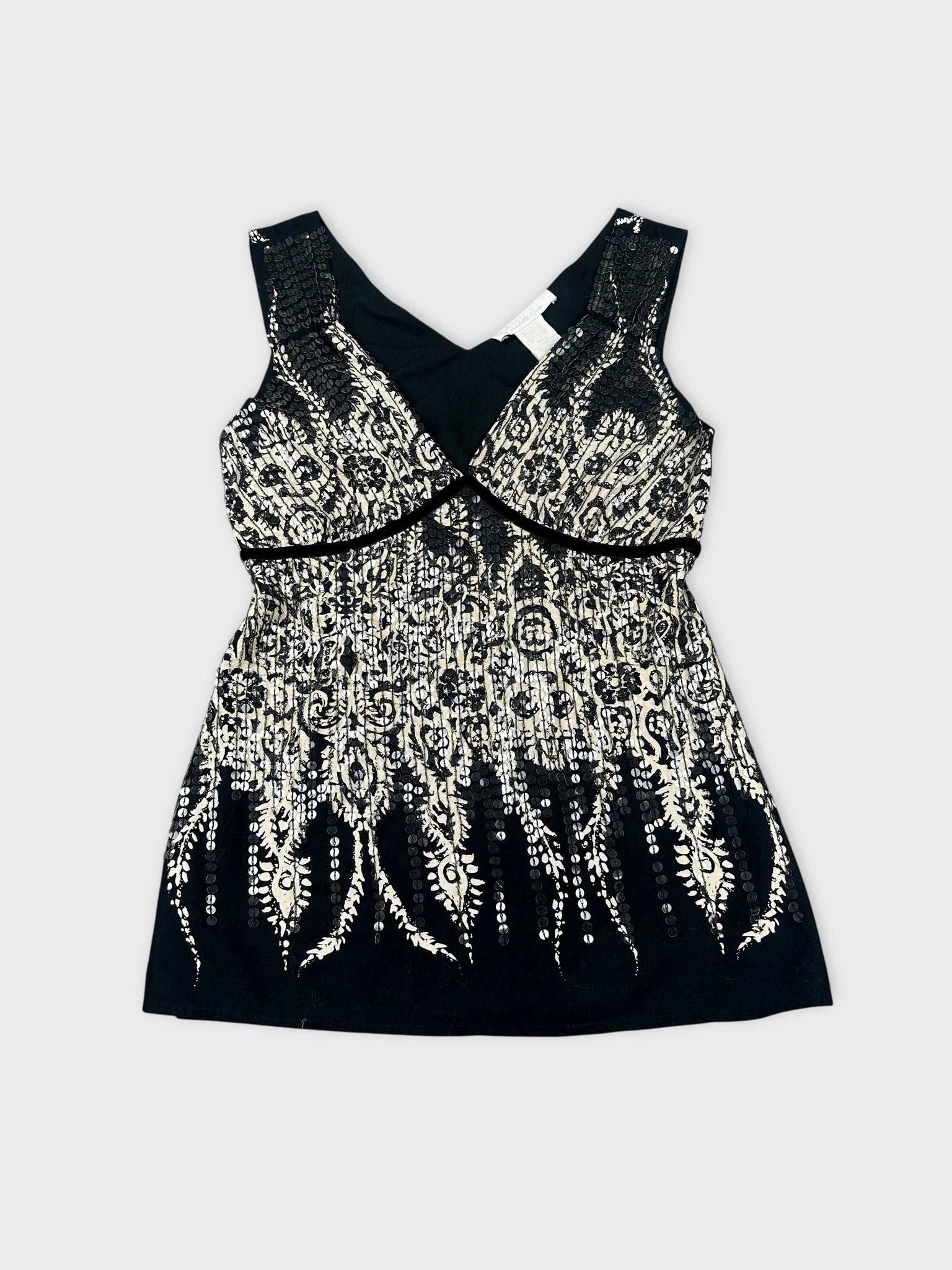 Front view of a black and white embellished tank top with lace pattern.