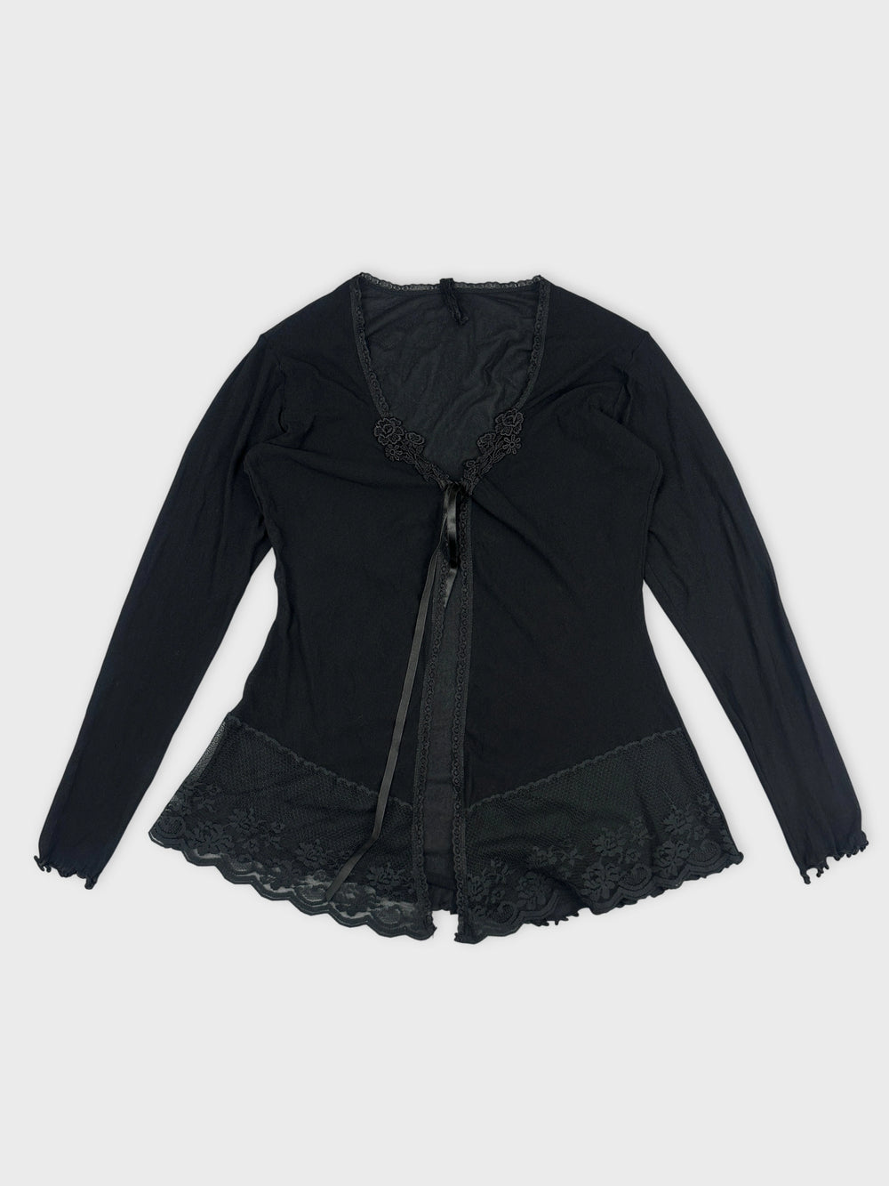 Black long-sleeve top with lace trim and ribbon tie front view.