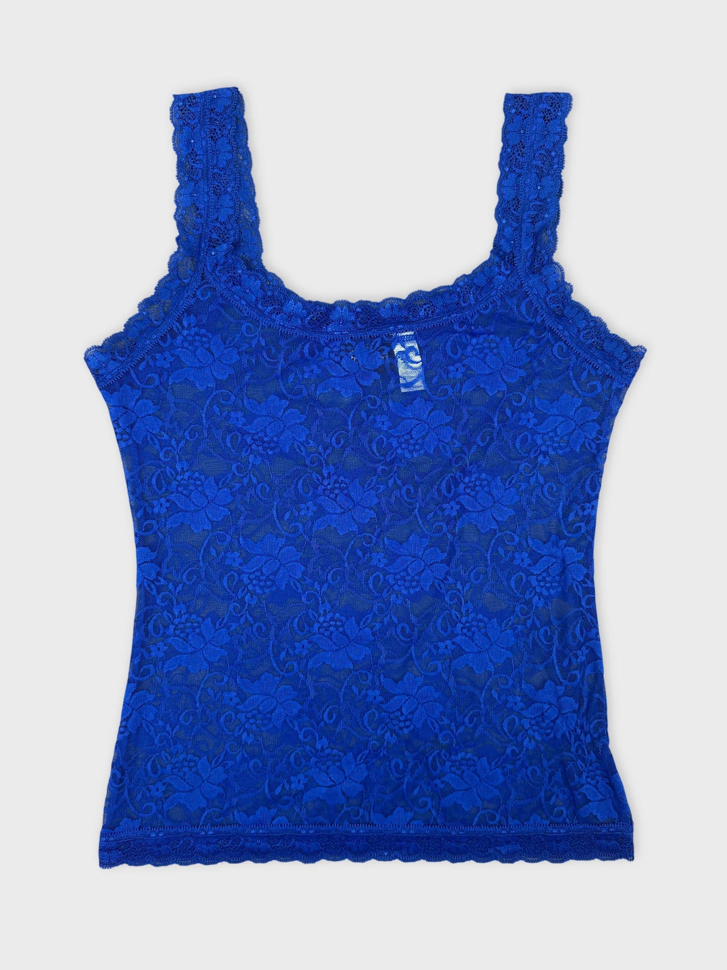 Front view of a blue lace tank top with floral pattern and scalloped trim.
