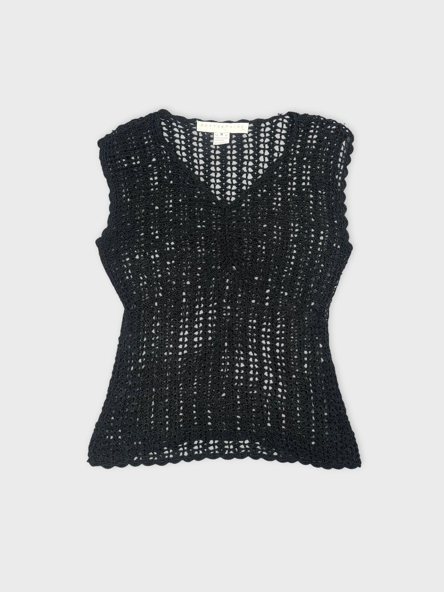 Black sleeveless top with a crochet pattern front view.