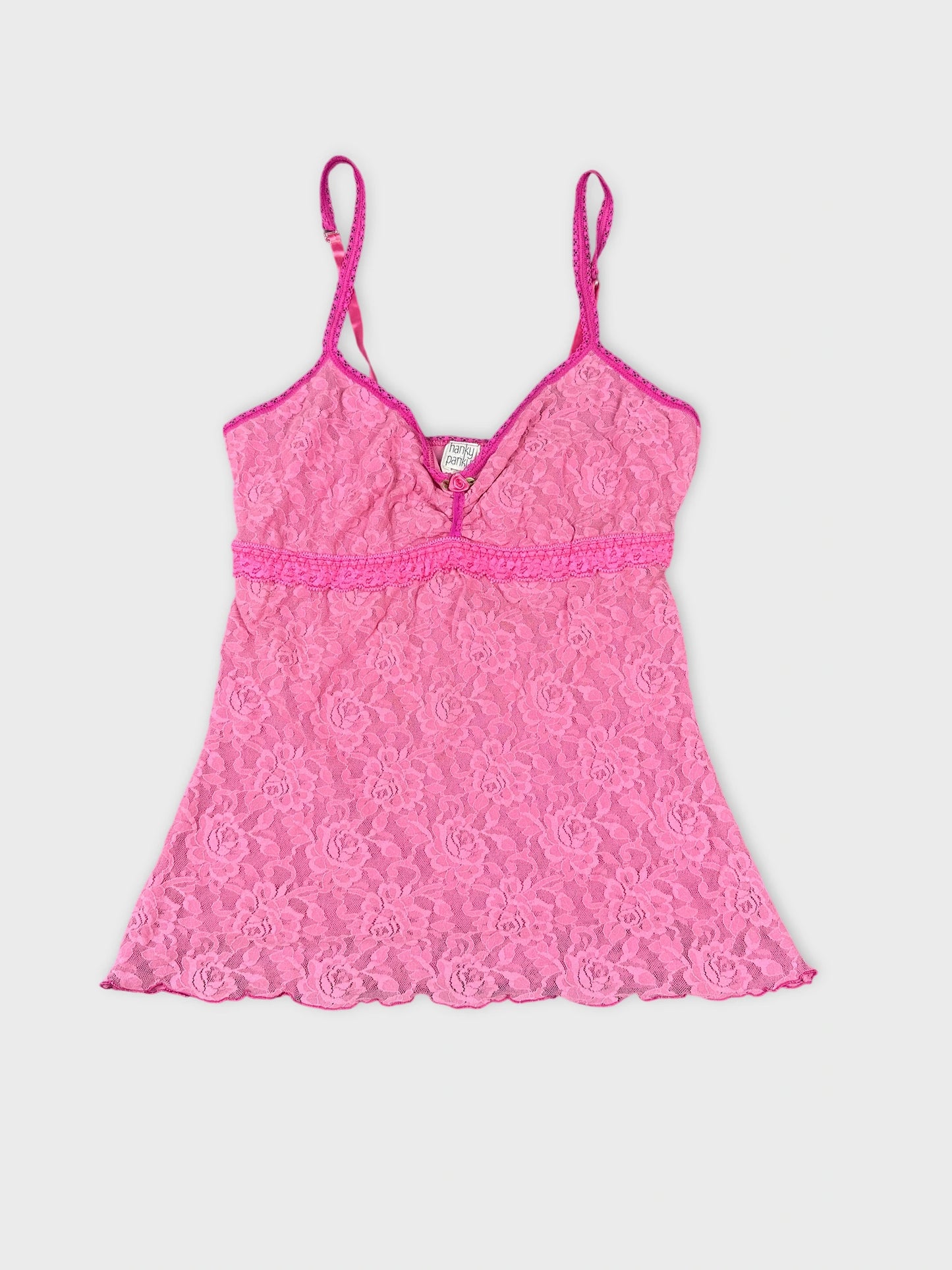 Front view of a pink lace top featuring floral pattern and adjustable straps.