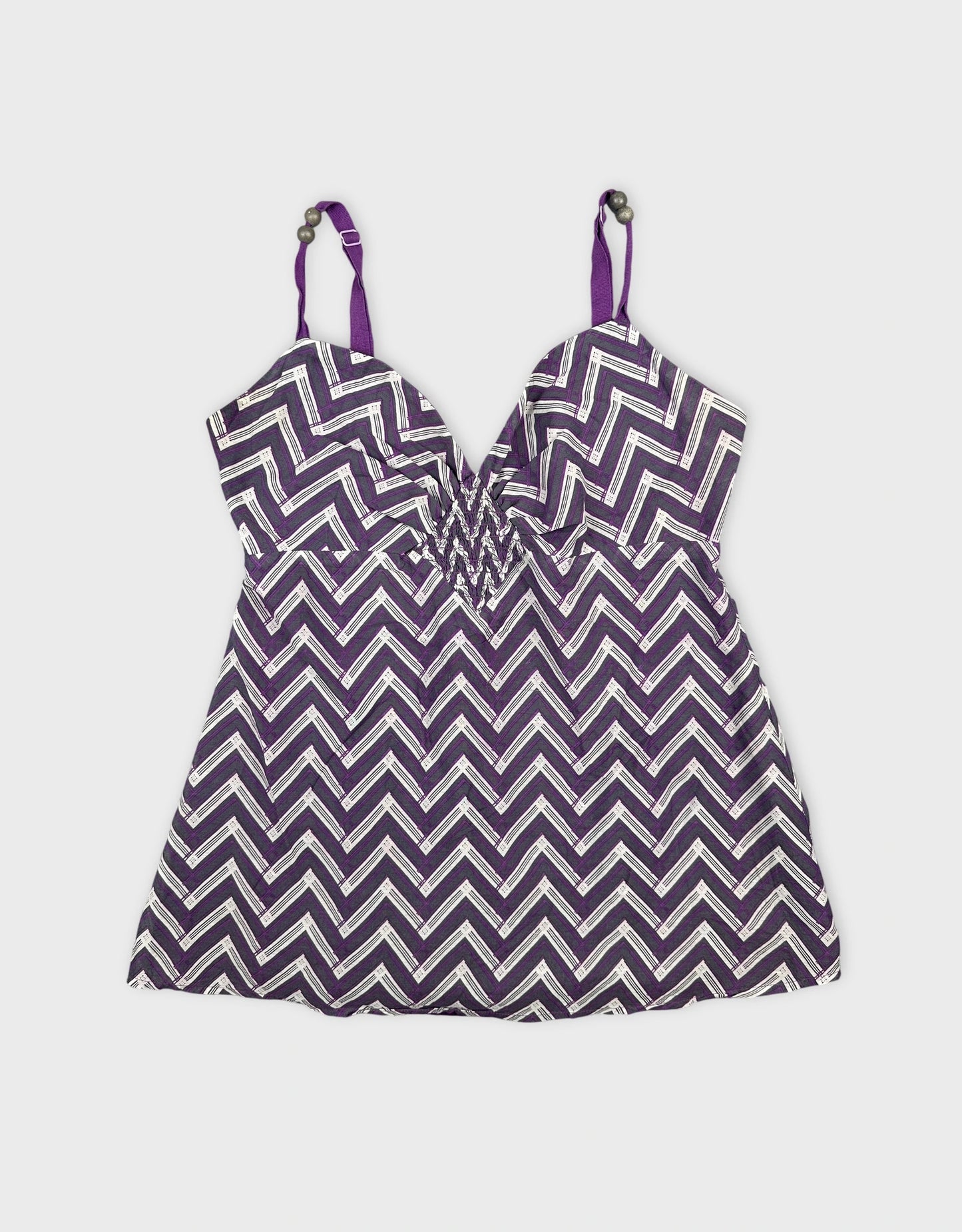Front view of a purple chevron patterned women's top with adjustable straps.