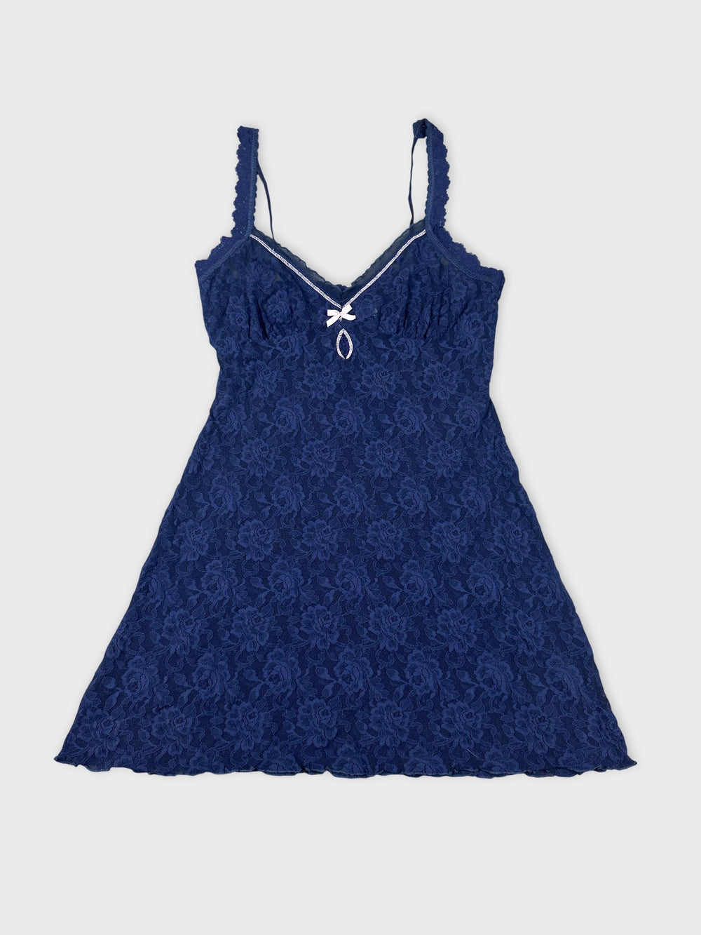 Navy lace top with a bow detail front view.