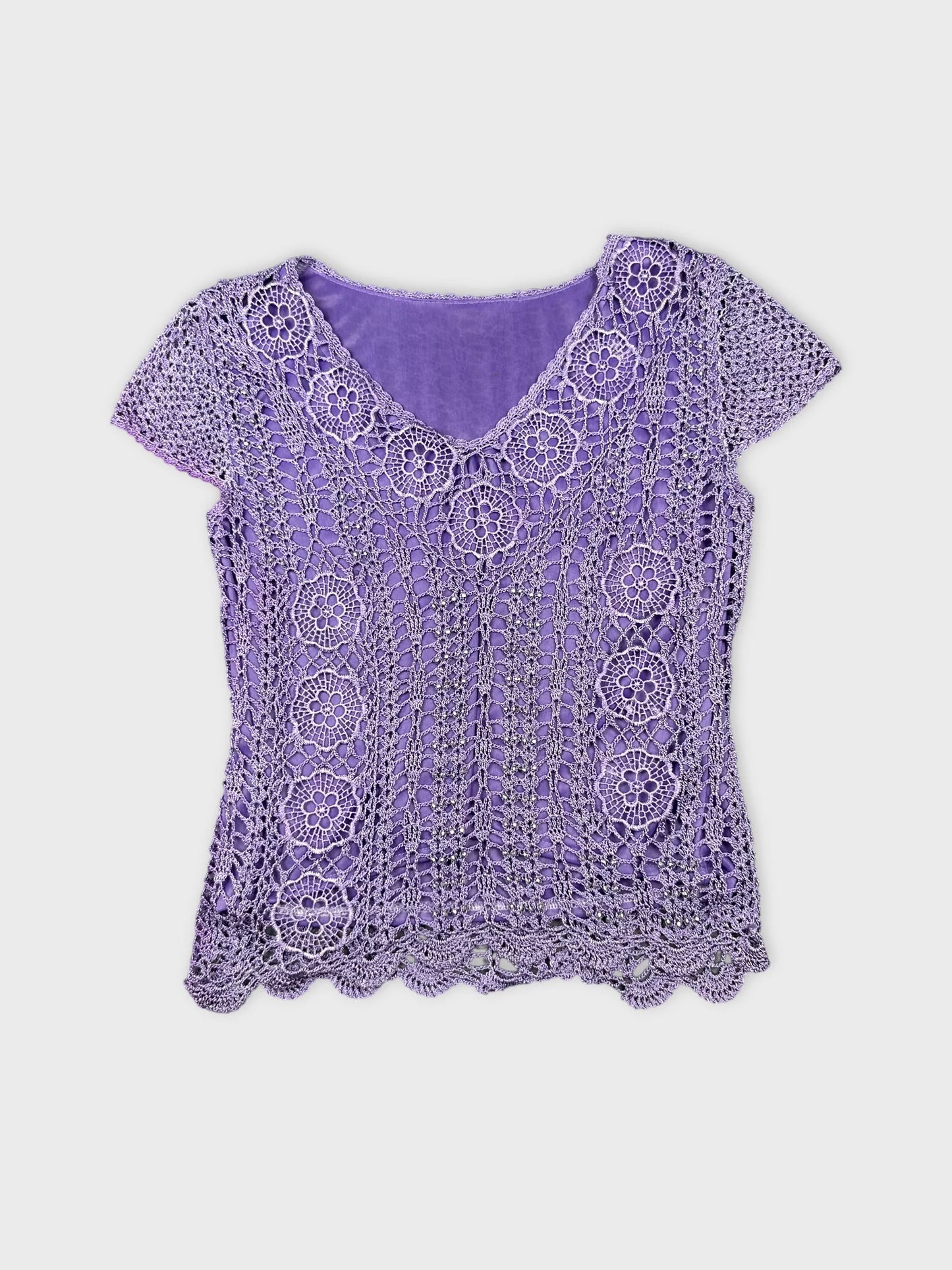 Front view of a purple crochet top with floral pattern.