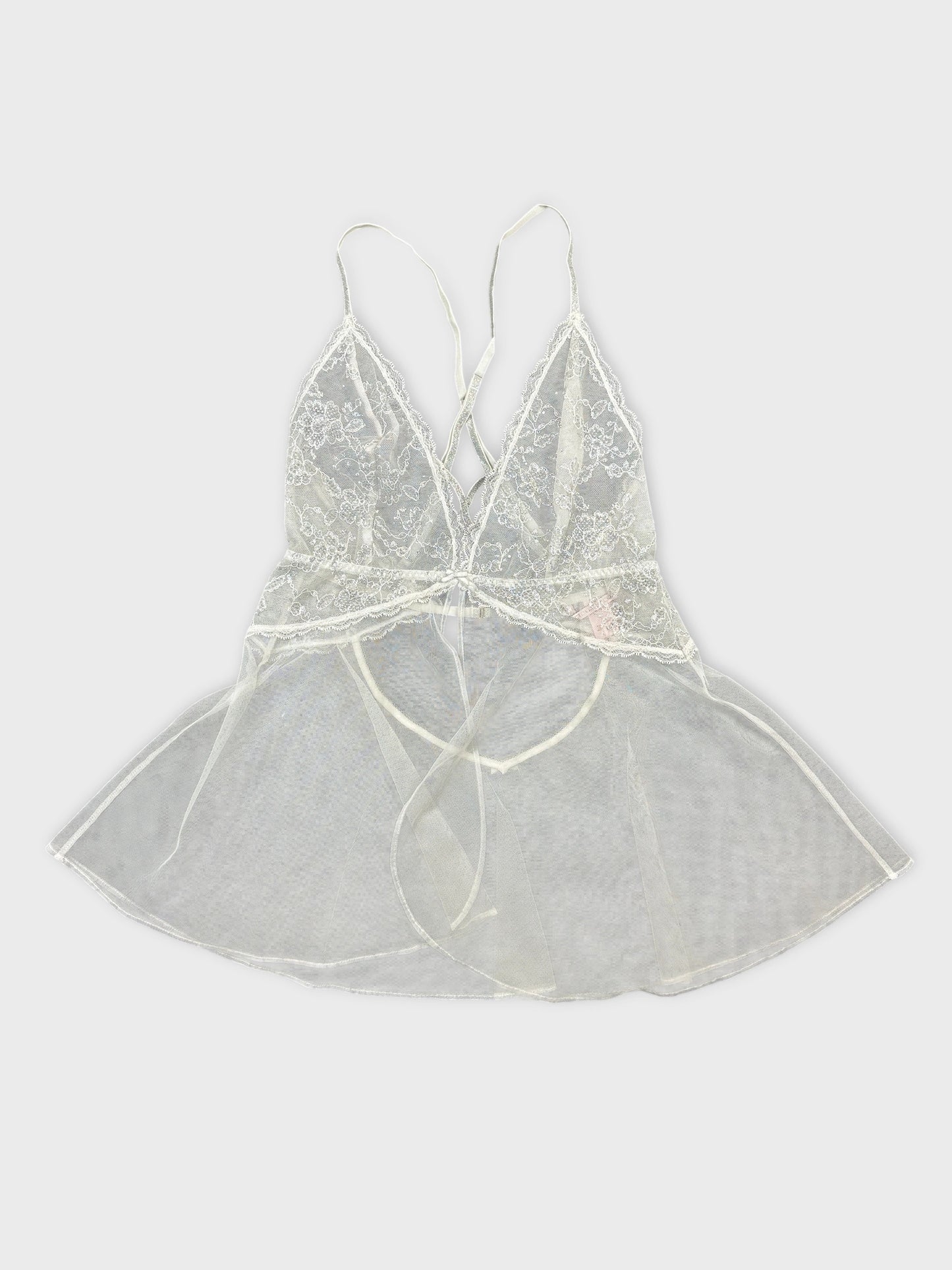 Front view of a vintage sheer lace top in light beige color with delicate trim.