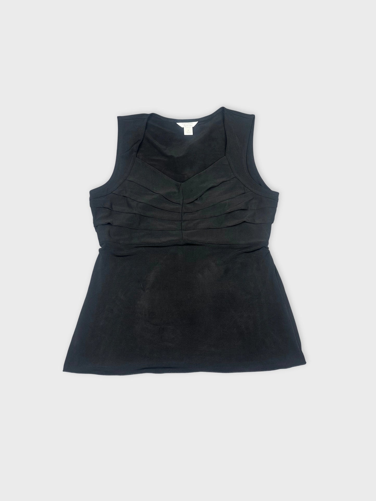 Front view of a black sleeveless top with layered detailing.