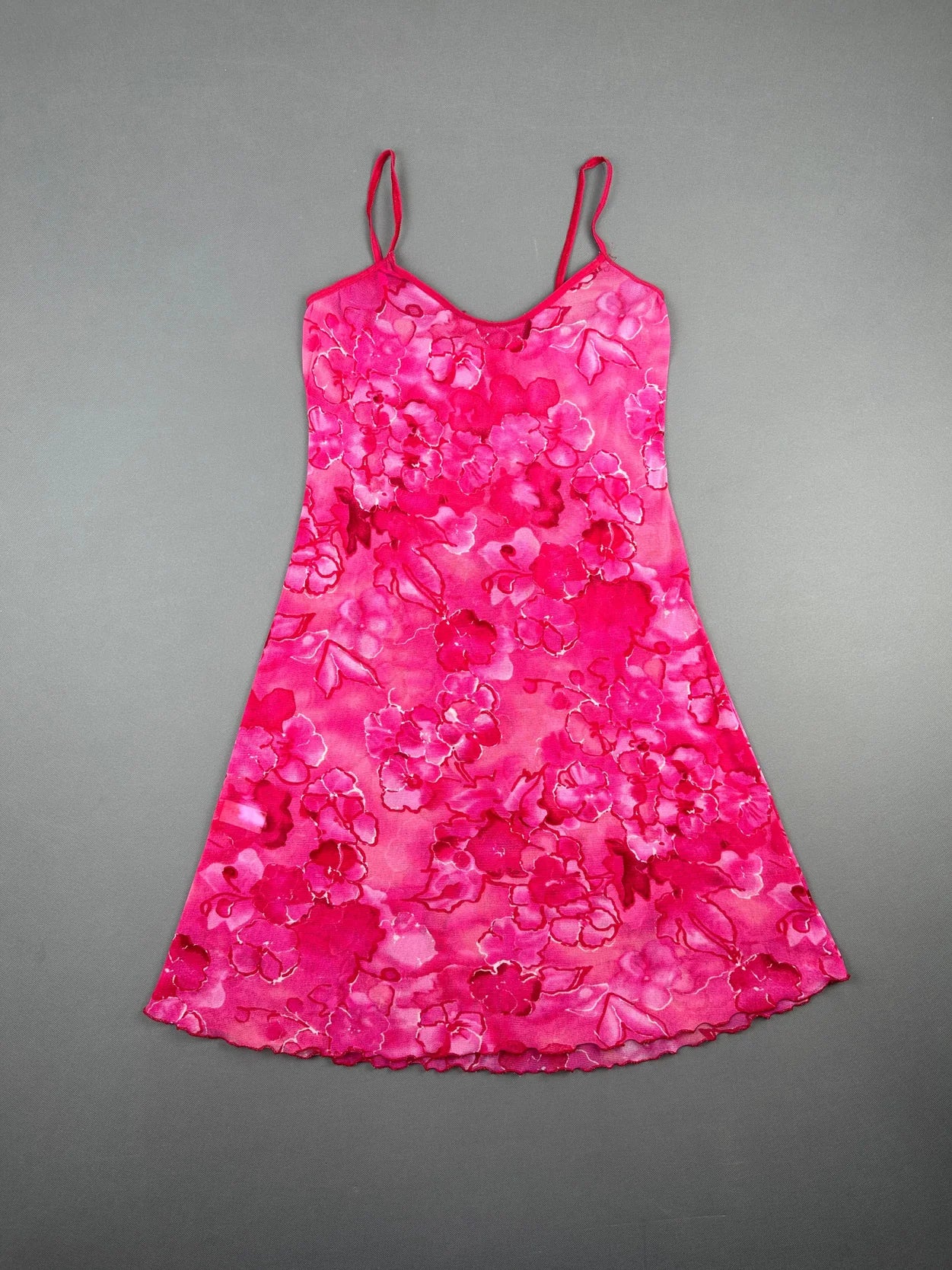 Front view of a pink floral sleeveless dress with thin straps.
