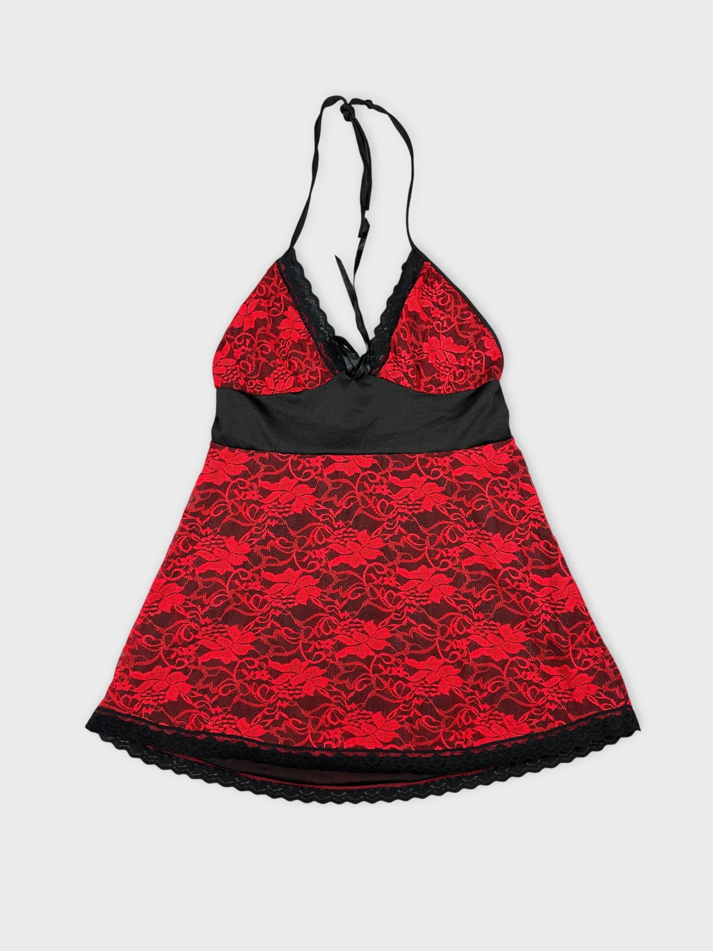 Front view of a red lace halter top with black trim.