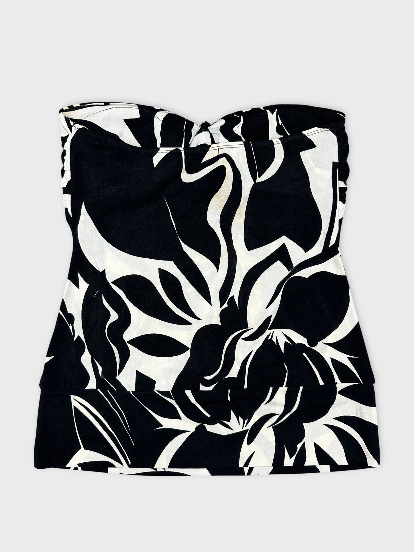 Front view of a black and white floral top with a fitted design.
