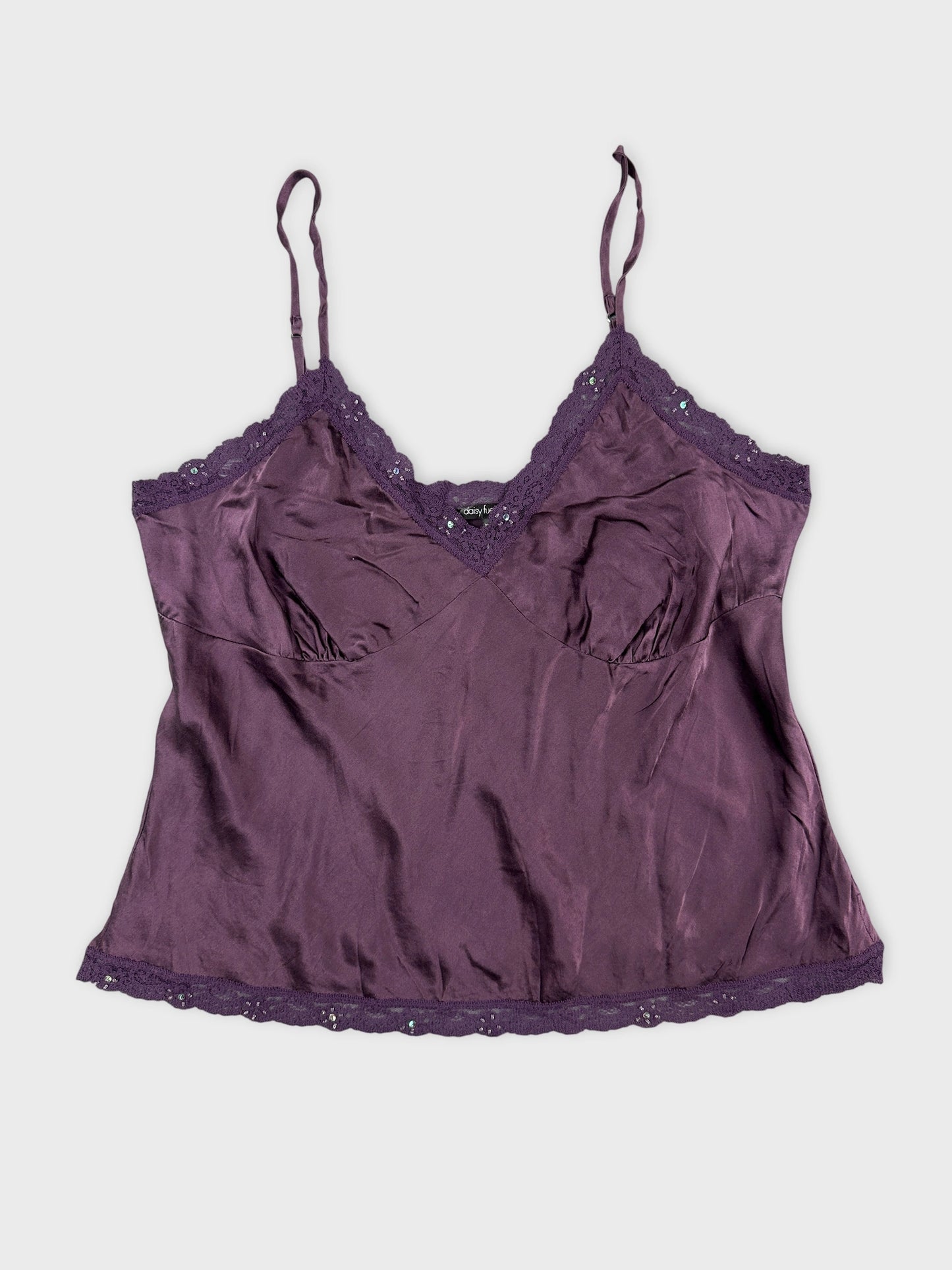 Front view of a purple satin camisole with lace trim.