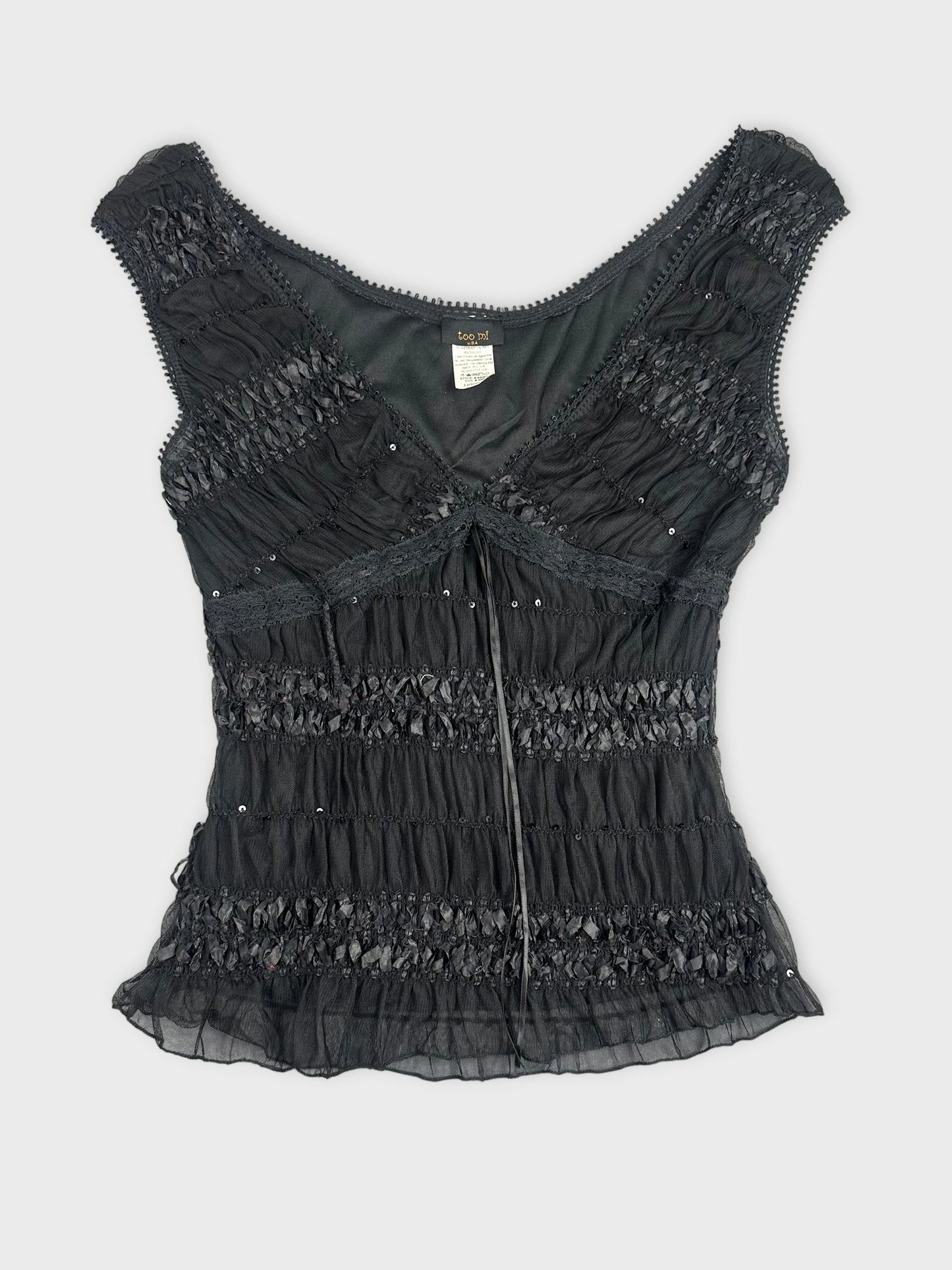 Black upper body top with ruffled texture and beaded details front view