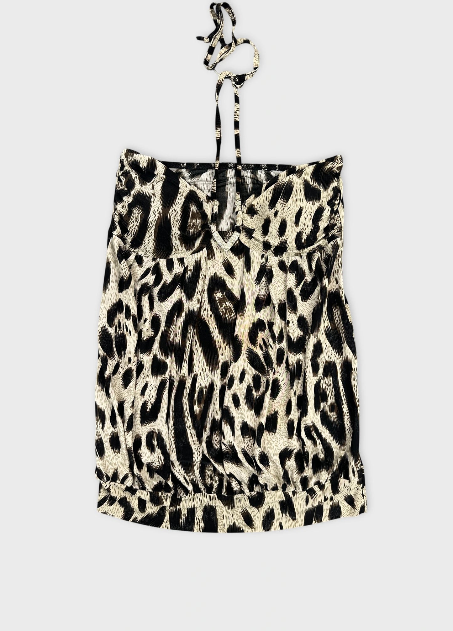 Front view of a vintage women's top in light cream with a black leopard print.