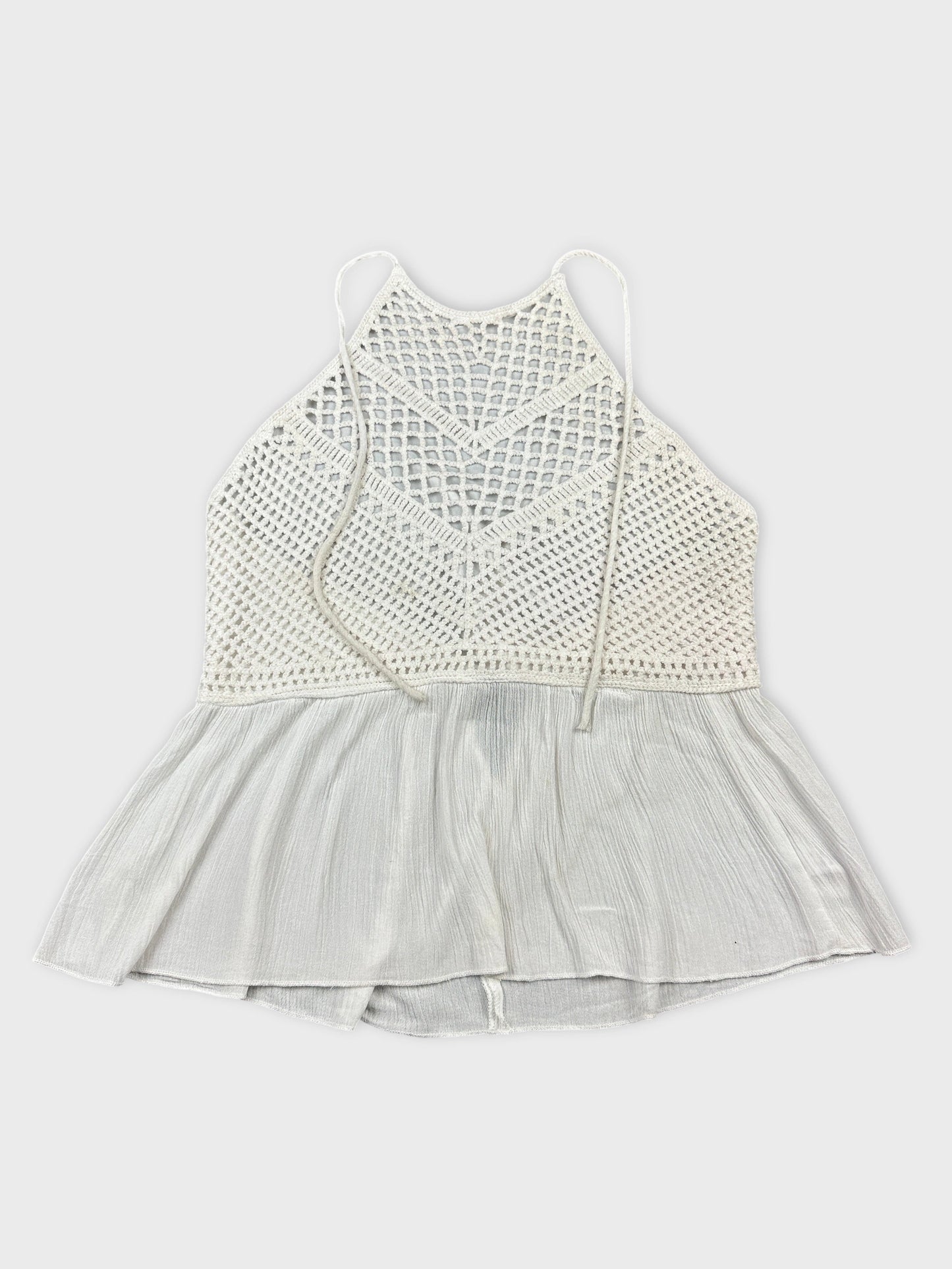 Front view of a white vintage crochet top with a flared hem