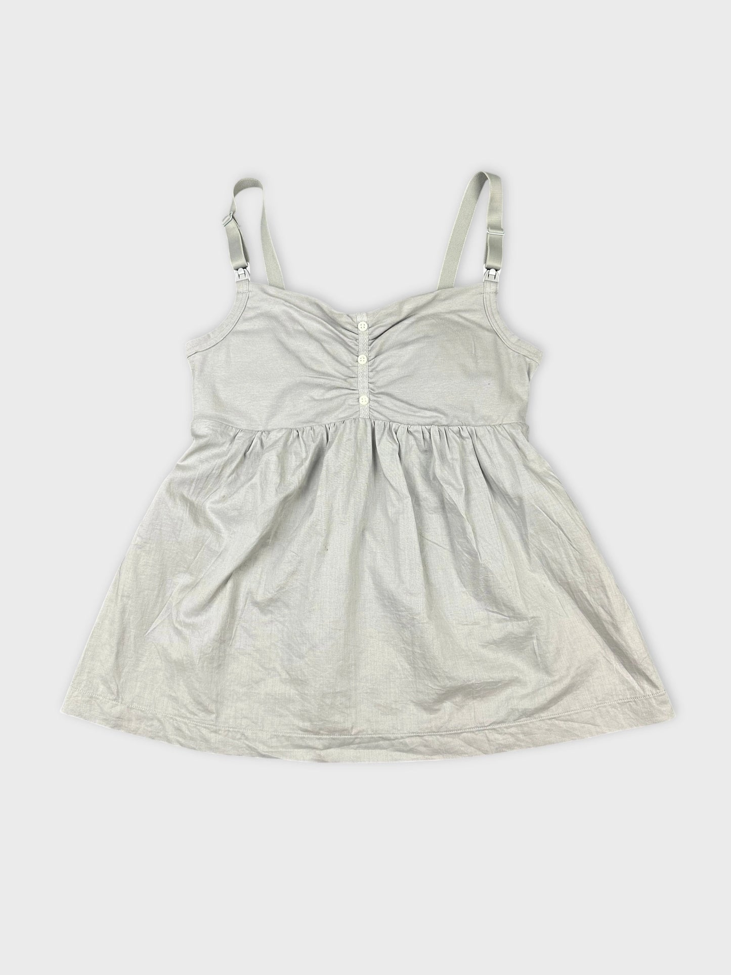 Front view of a light gray women's top featuring a gathered bodice and buttons.