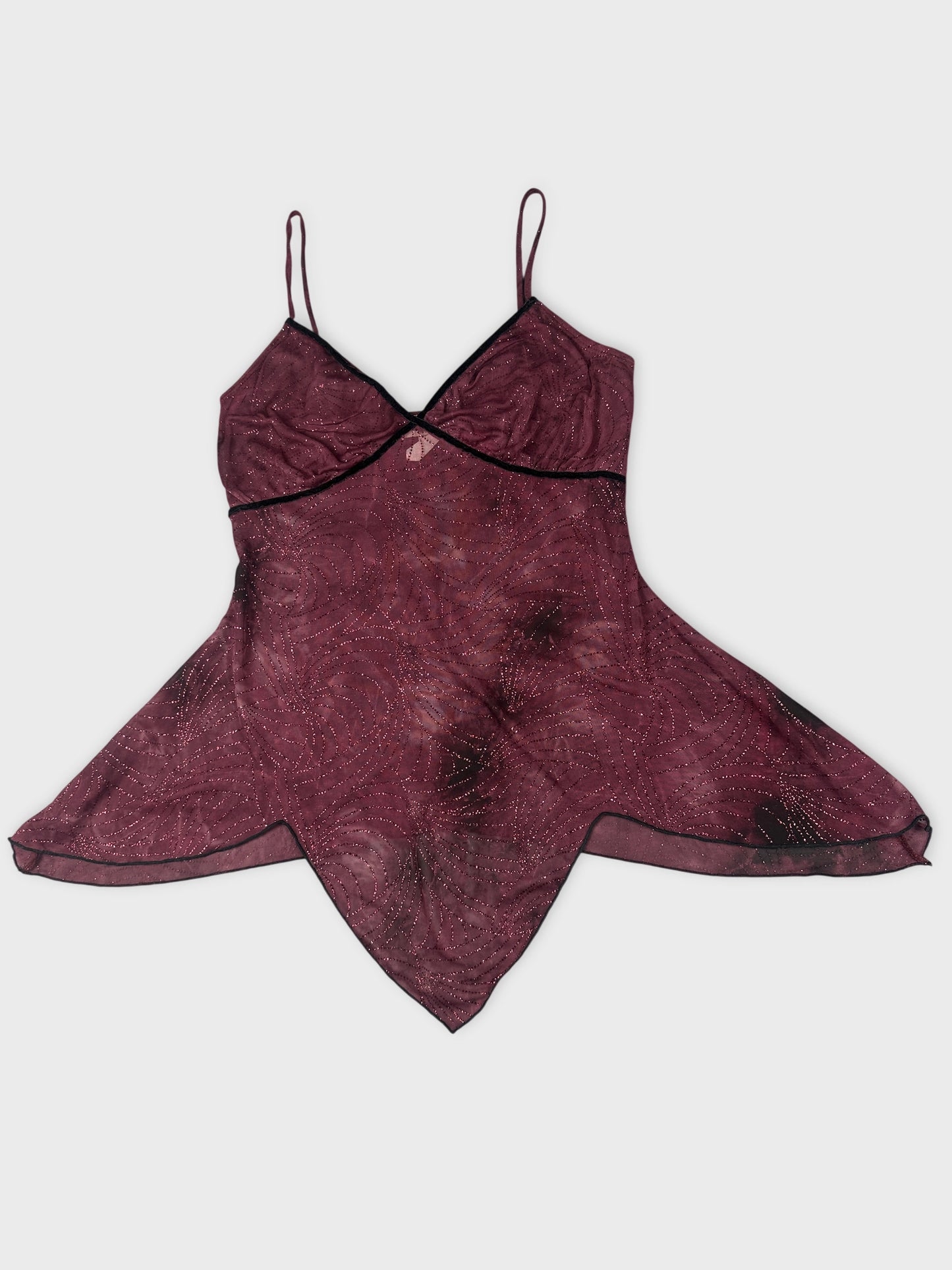 Front view of a burgundy vintage top with a swirling pattern and black trim.