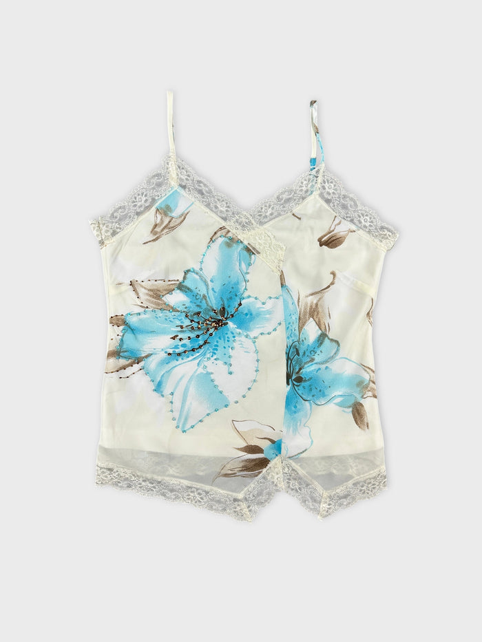 Front view of a floral print light blue camisole with lace trim.