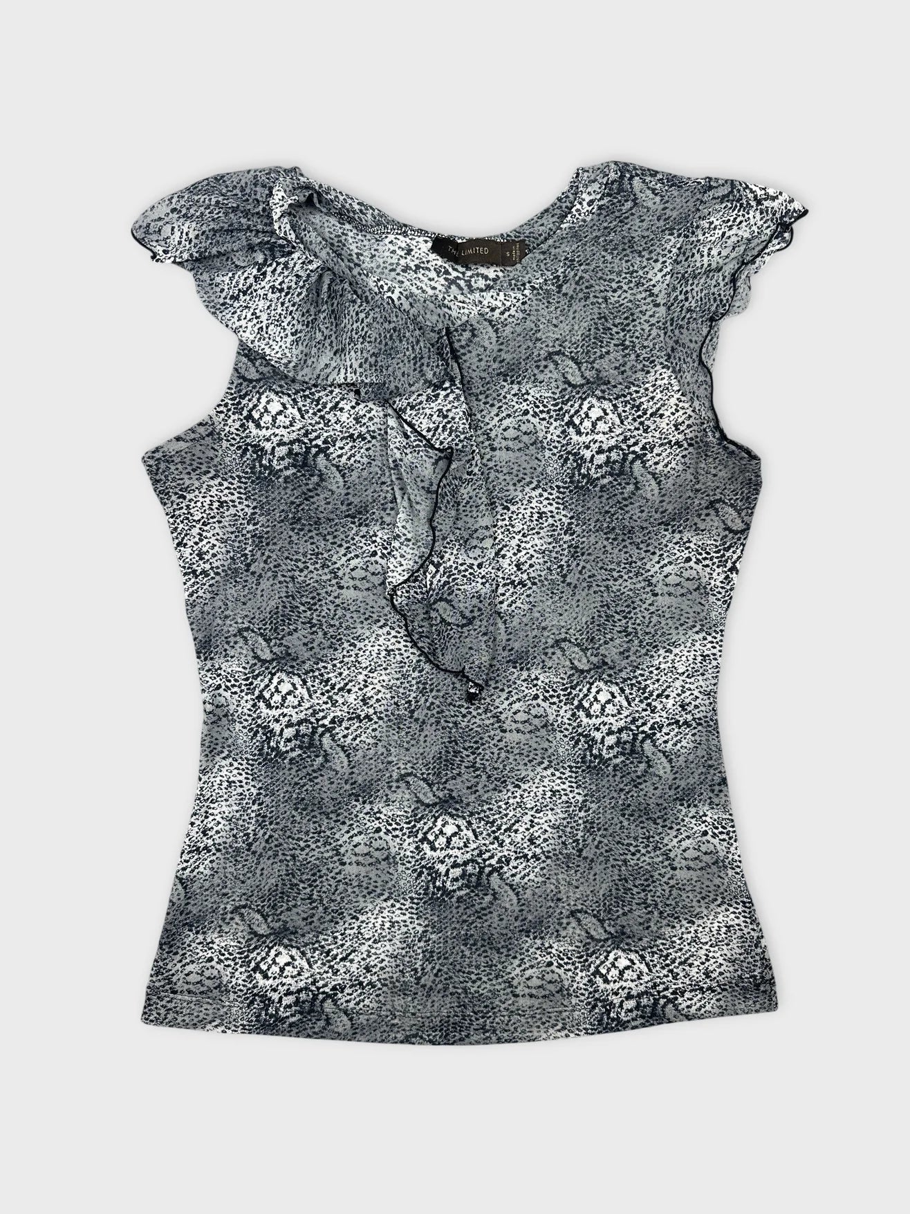 Front view of a black and white patterned sleeveless top with ruffled trim.