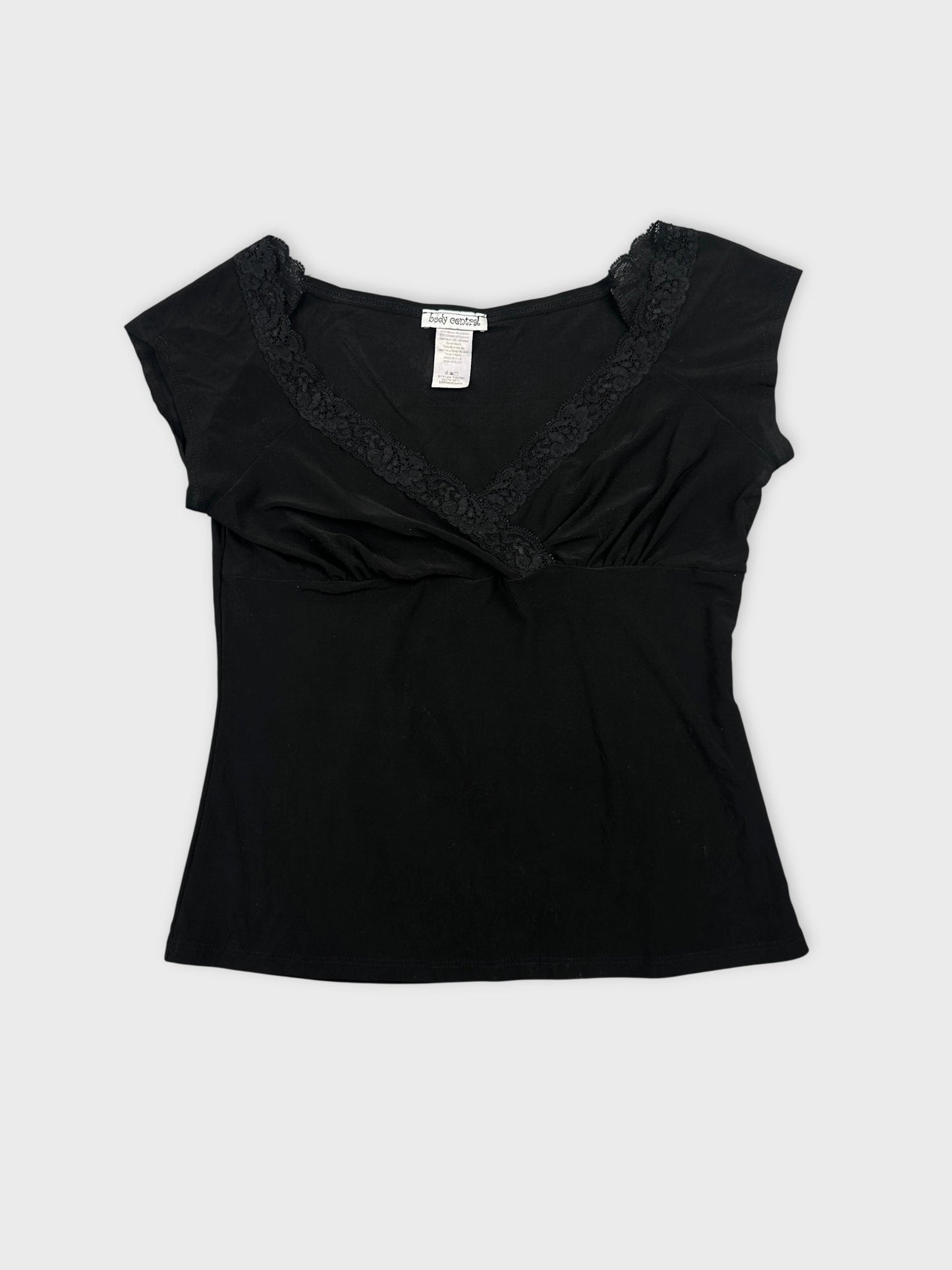 Black top with lace trim in front view.