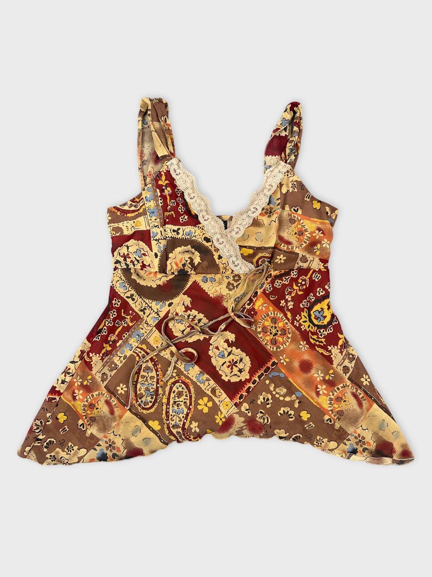 Front view of a vintage brown patterned top with lace trim.