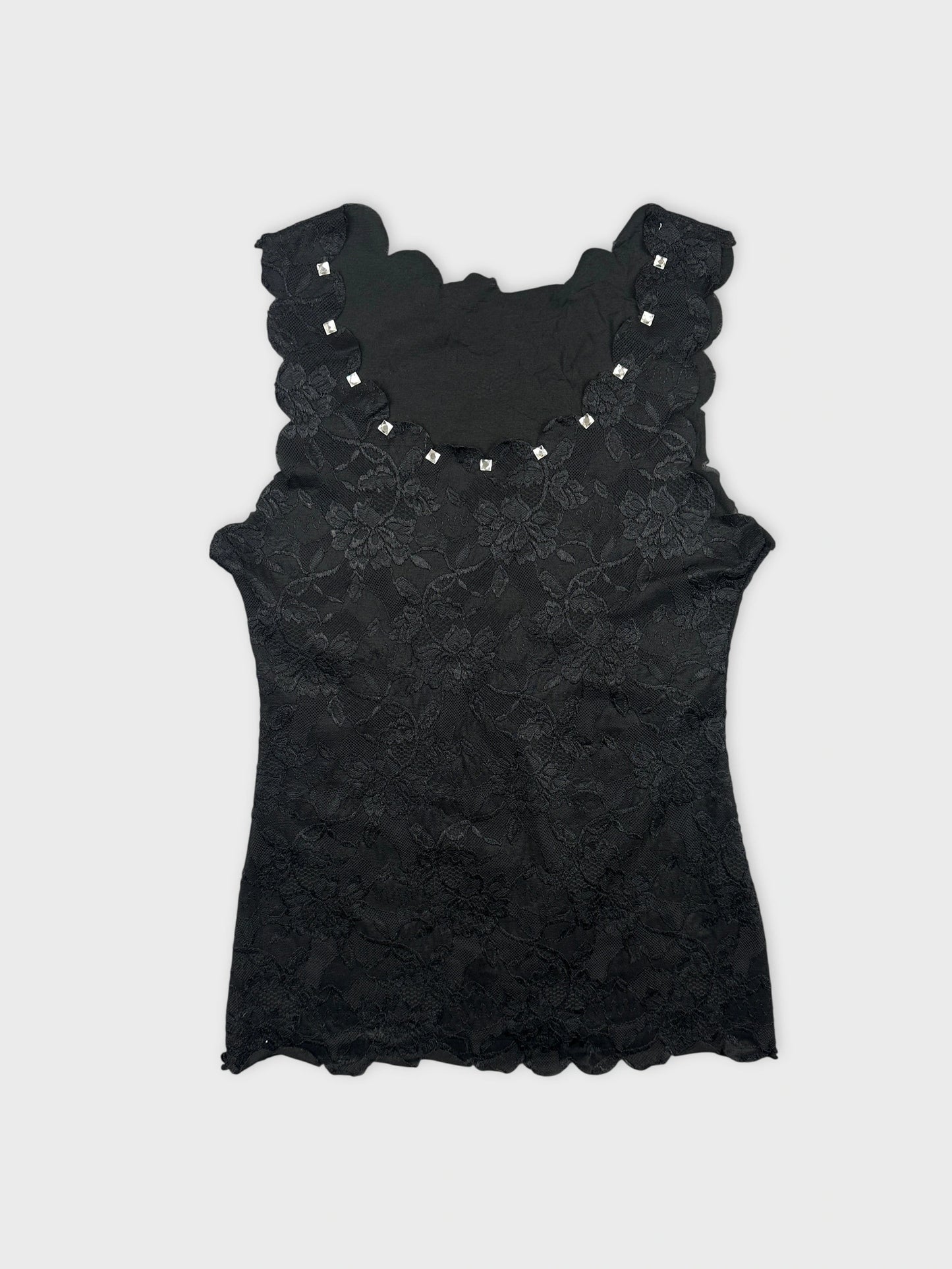 Front view of a black lace top featuring scalloped edges and decorative embellishments.