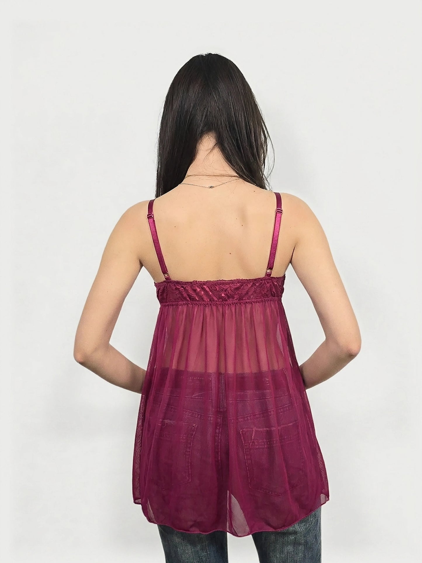 Back view of a sheer burgundy top with thin straps and gathered neckline.