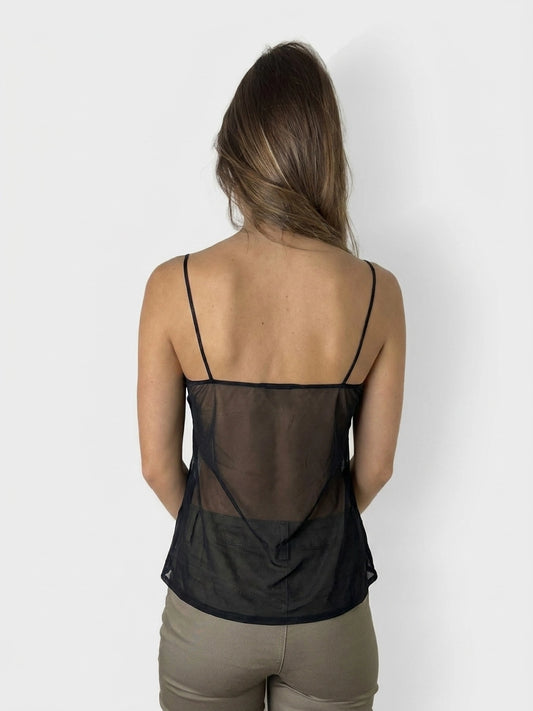 Back view of a black mesh top featuring adjustable spaghetti straps.