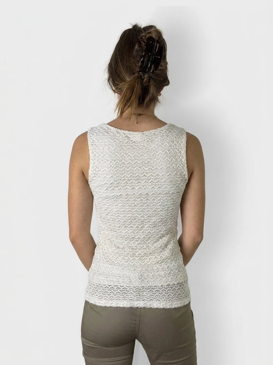Back view of a white lace tank top with a wavy pattern.