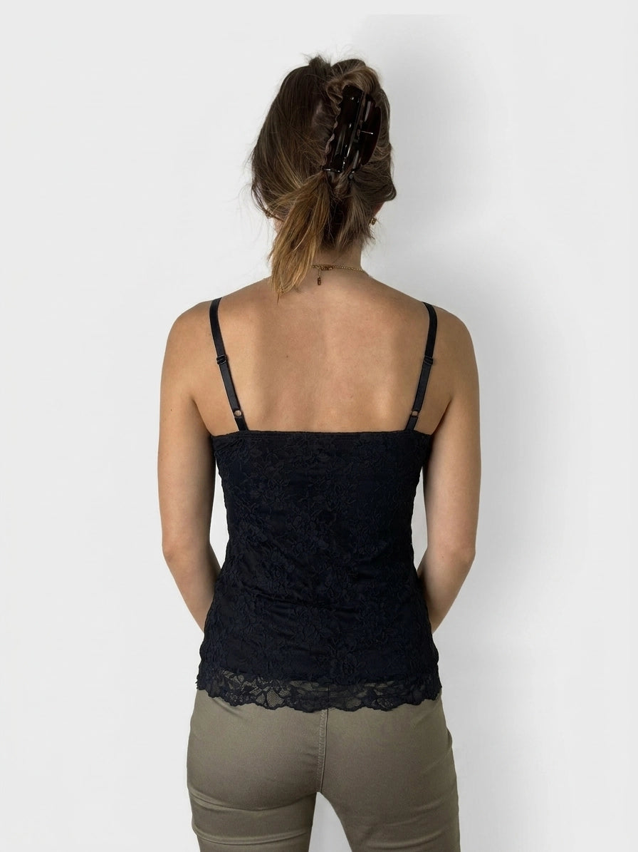 Back view of a black lace camisole with spaghetti straps.