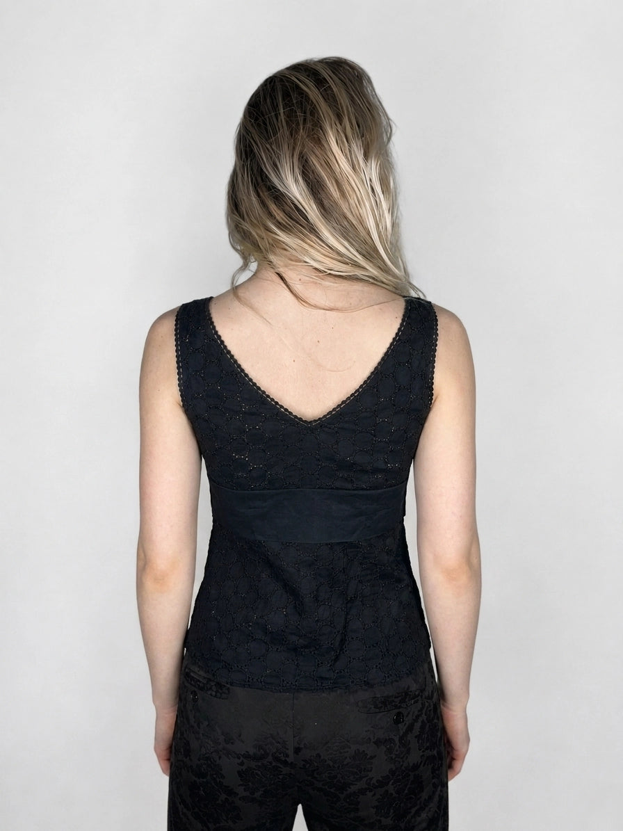 Back view of a black women's upper body top featuring a lace pattern.