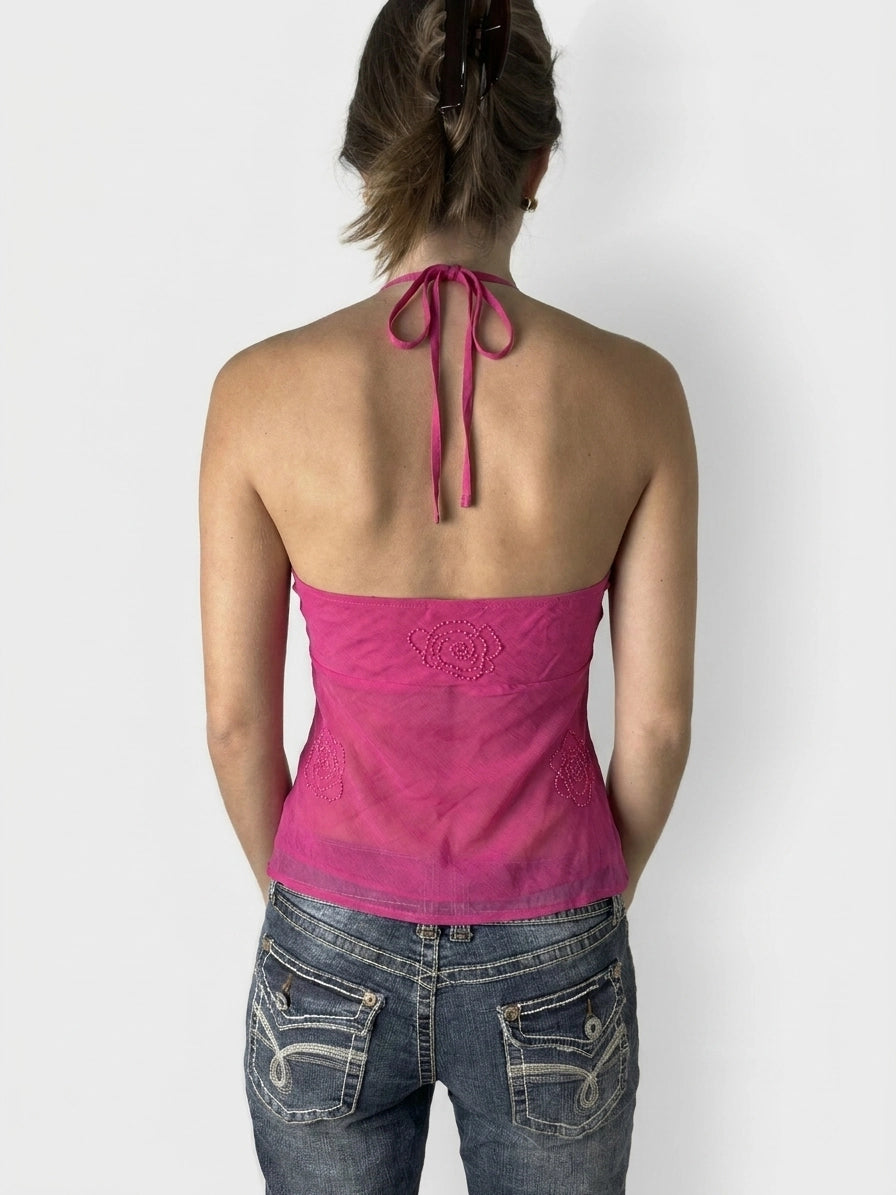 Back view of a pink halter top with floral embroidery detail.