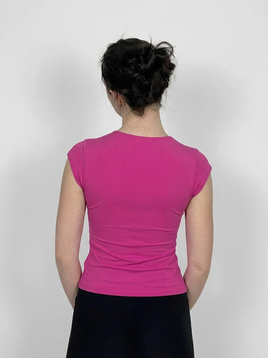 Back view of a fitted pink women's top with short sleeves.