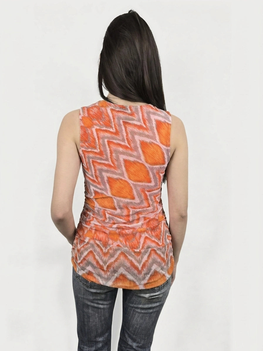 Back view of a sleeveless orange top featuring a zigzag pattern.