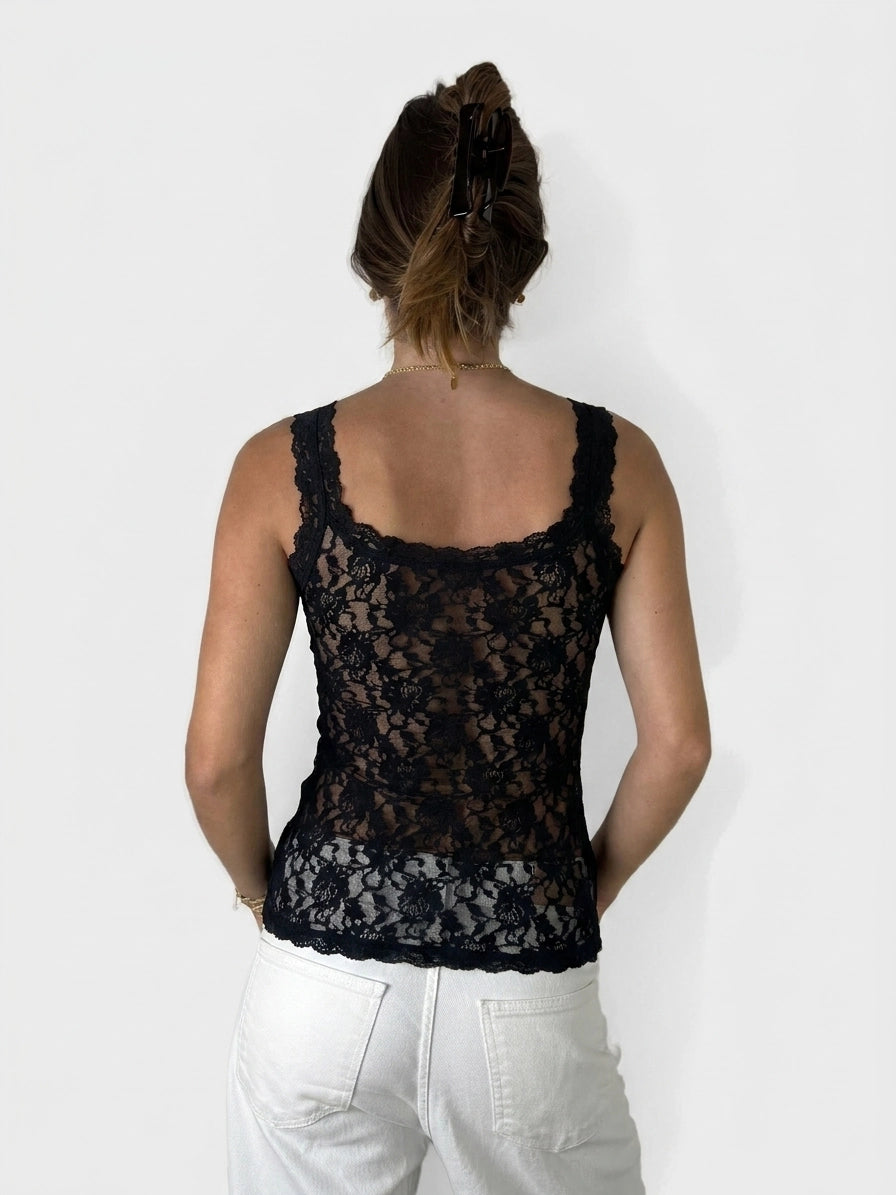 Back view of a black lace women's top with scalloped trim.