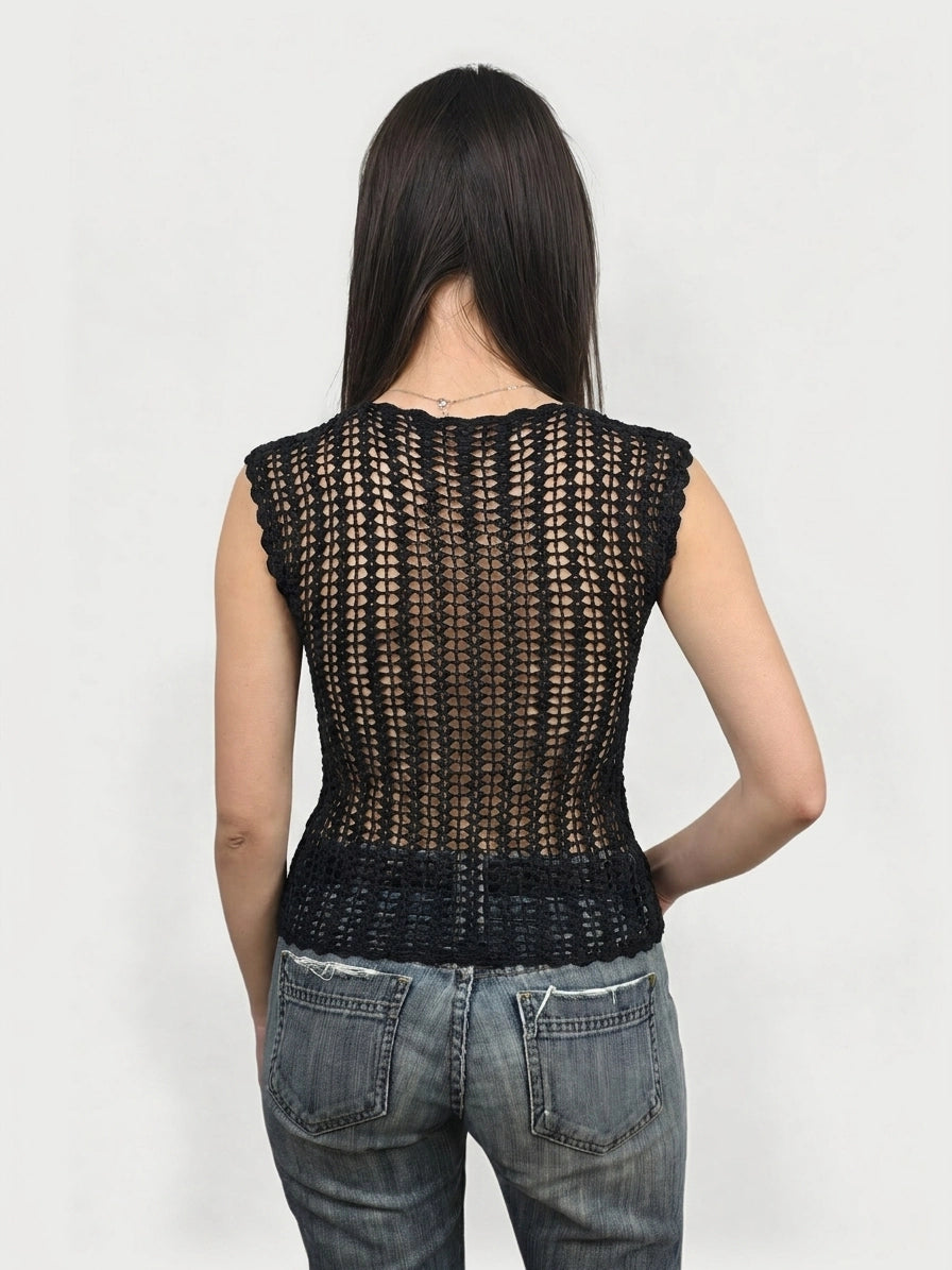 Back view of a black crocheted upper body top with cap sleeves.