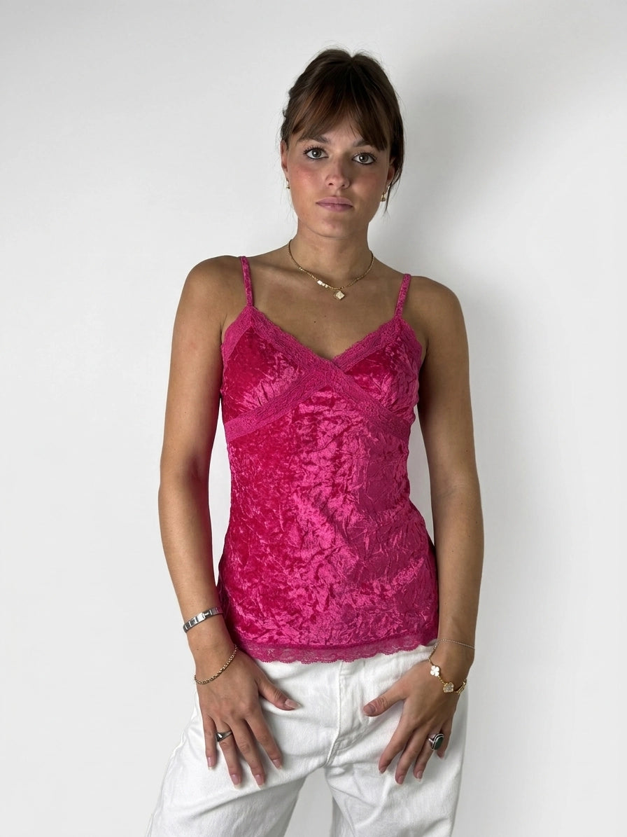 Front view of a vibrant pink lace top featuring adjustable straps.