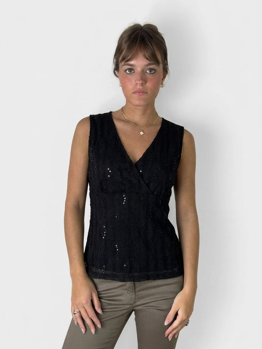 Black wrap top with a textured pattern, front view.