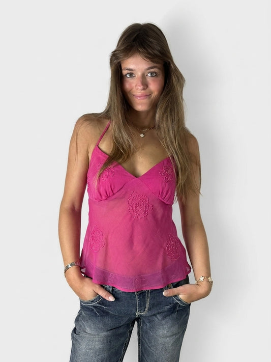 A pink upper body top featuring floral embroidery, shown in front view.
