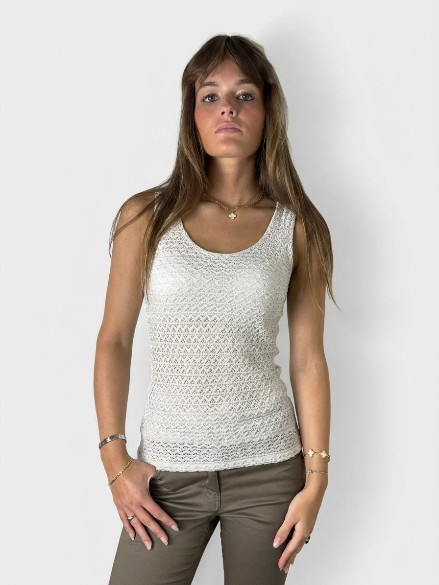 Front view of a white knit tank top featuring a textured pattern.