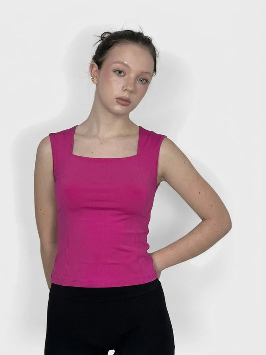 Front view of a pink women's upper body top with square neckline.