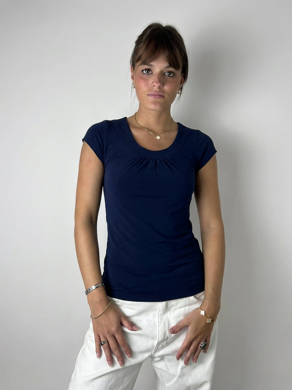 Front view of a navy blue women's top with gathered detail.