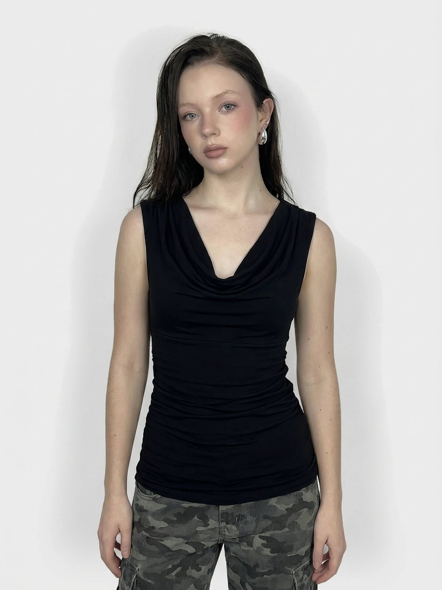 Black sleeveless top with draped neckline, front view.