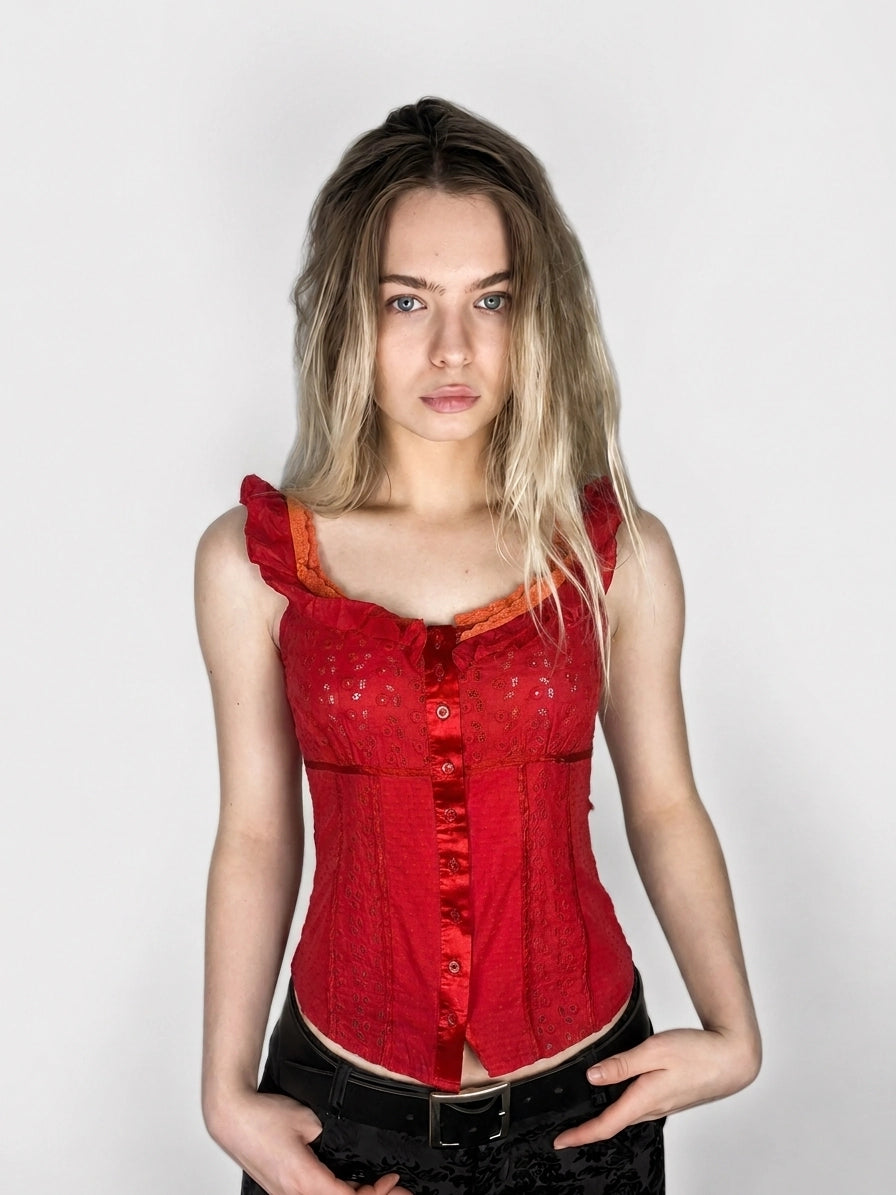 Red women's upper body top with ruffled straps and button front, front view.